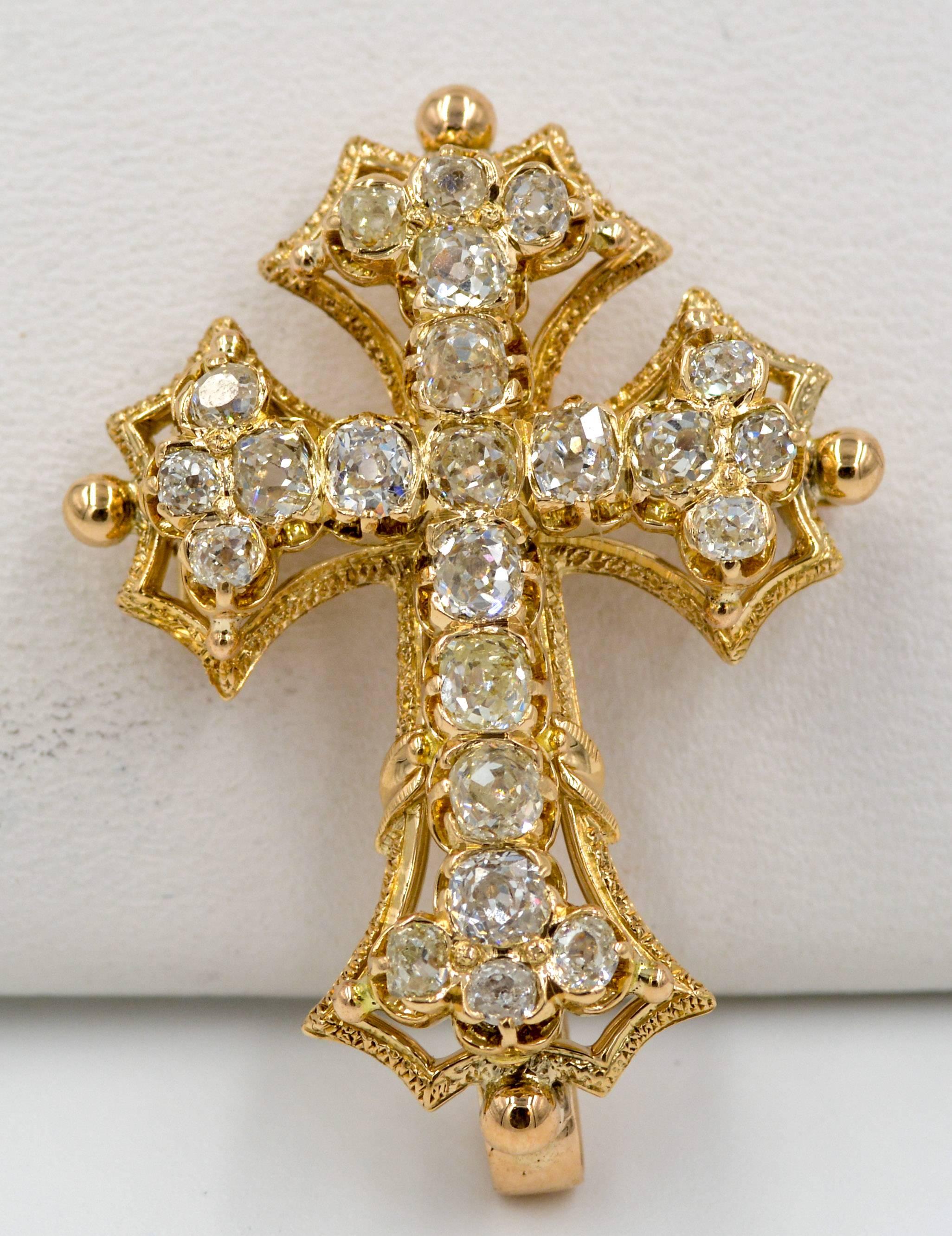 This classic Victorian era cross pendant/pin is an amazing example of 19th century craftsmanship and beauty.  The cross is made entirely of 18kt yellow gold and is set with twenty three old mine cut diamonds that show case the diamond cutting