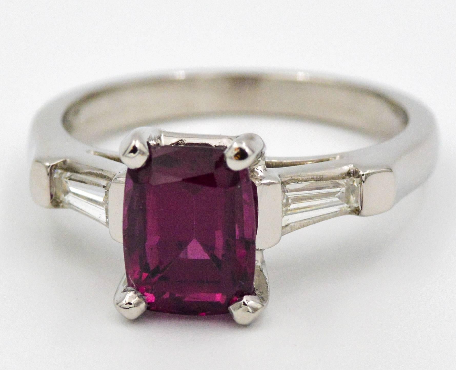 This stunning ring features a radiant cut red garnet that weighs 2.79 carats.  The garnet is contrasted by two beautiful tapered baguette cut diamonds.  The two baguette cut diamonds have combined weight of 0.30 carats with g-H color and VS clarity.