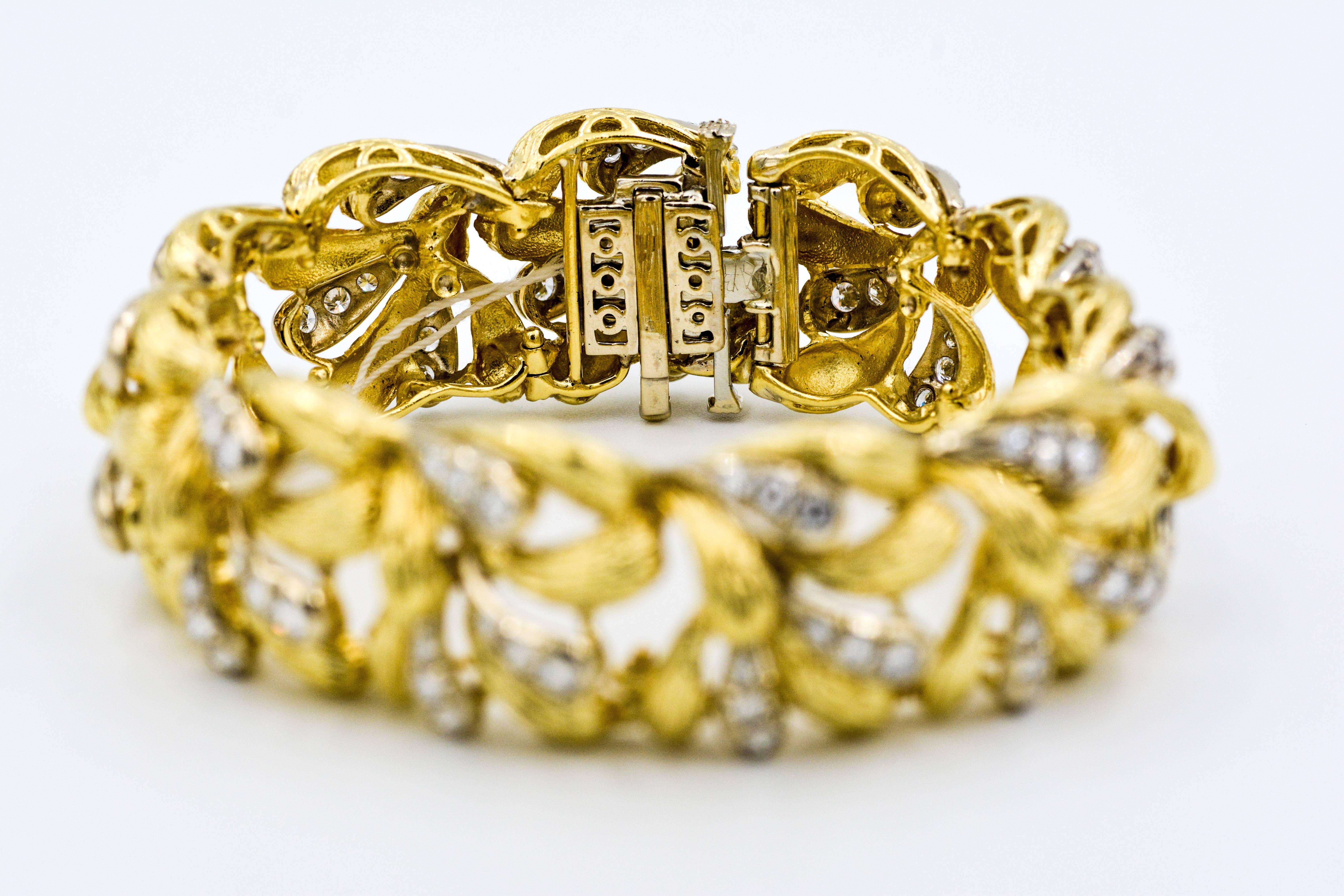 This stunning 18k yellow gold and diamond bracelet is executed with an attractive three dimensional textured paisley design.  The bracelet is set with 99 round brilliant cut diamonds with an approximate total weight of 1.25 carats G-H color and VS