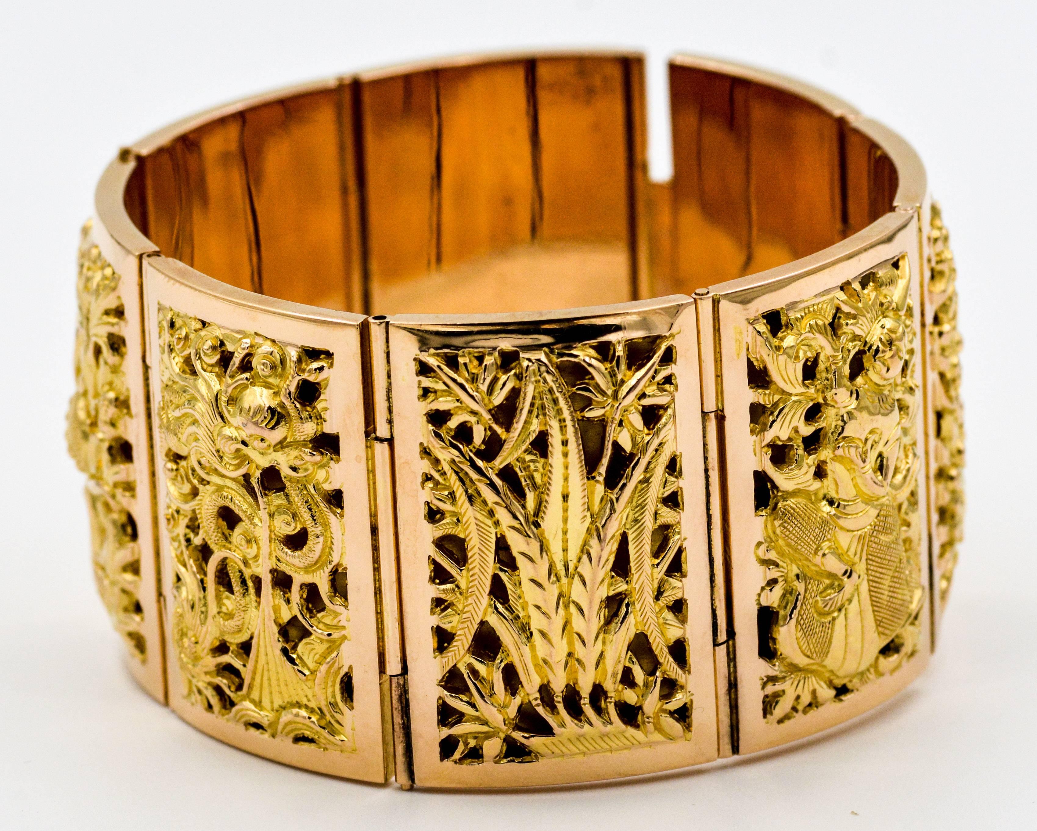 This exquisite 18 Karat classic Asian panel bracelet portrays the four seasons with a Chrysanthemum-Autumn, Bamboo-Winter, Peach Blossom-Spring, and Orchid-Winter.  Additionally this panel bracelet portrays two panels of a dancing woman.  This