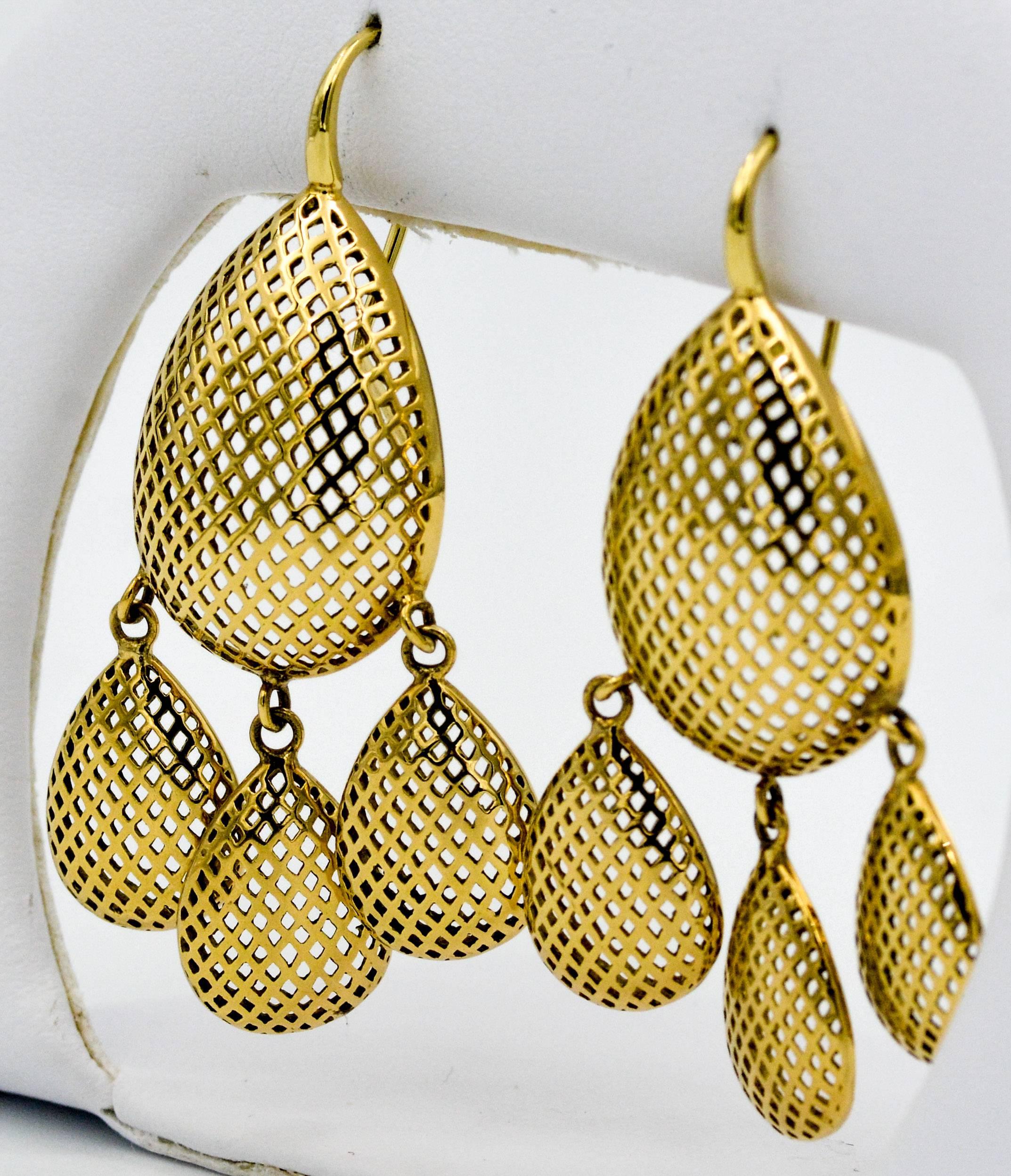 Release the artist within and capture all the attention in these classic Ray Griffith Chandelier earrings. Ray Griffin executed his signature style of artistic open work in these 18 karat yellow gold earrings. The 18 karat gold earrings are