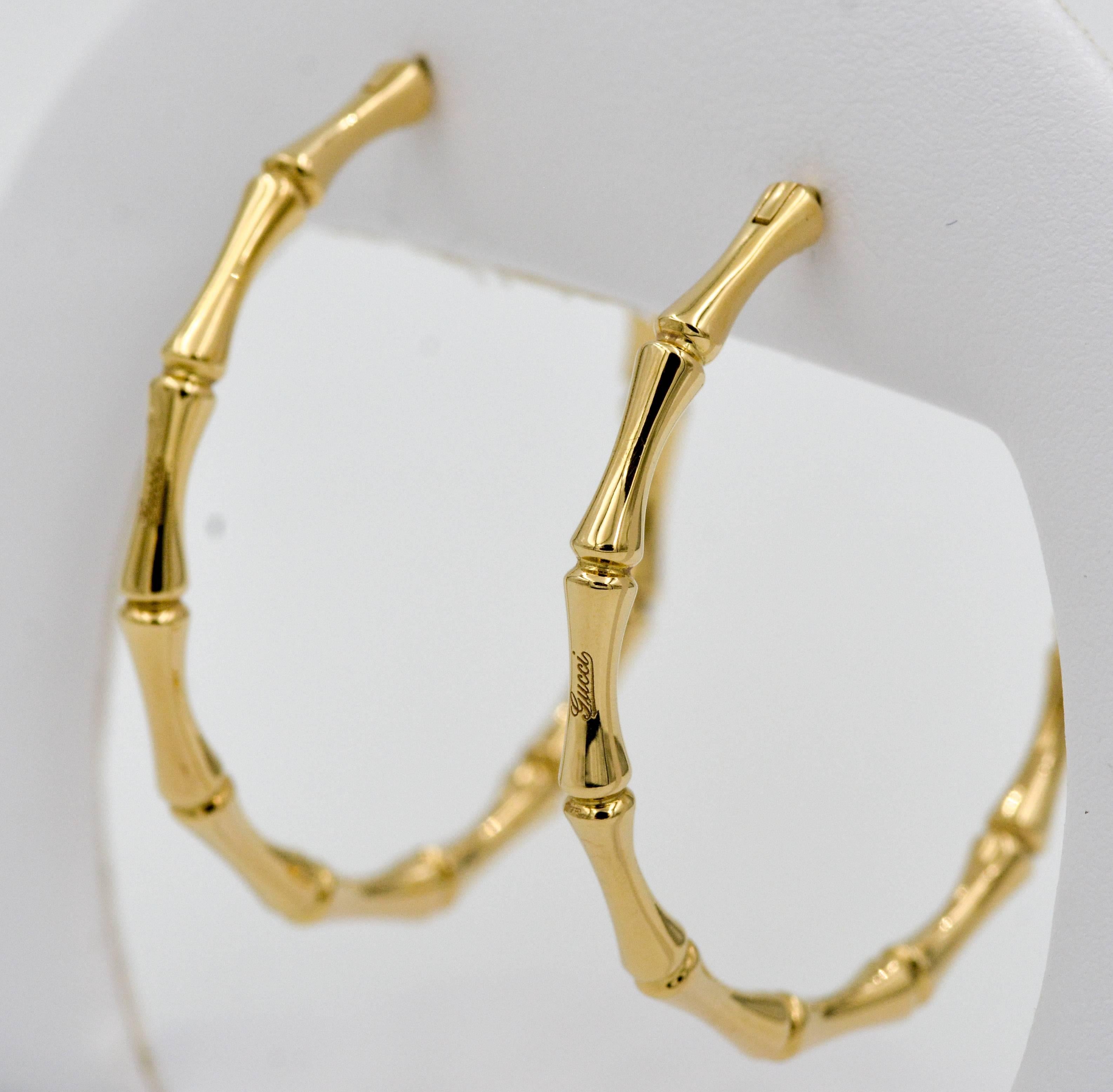 These elegant 18kt yellow gold Gucci earrings are done in the signature bamboo style. The hoops measure 4.5 mm in over all diameter with a thickness of 3.21 mm.  The earrings are secured by a comfortable hinged wire.  These classic Gucci earrings