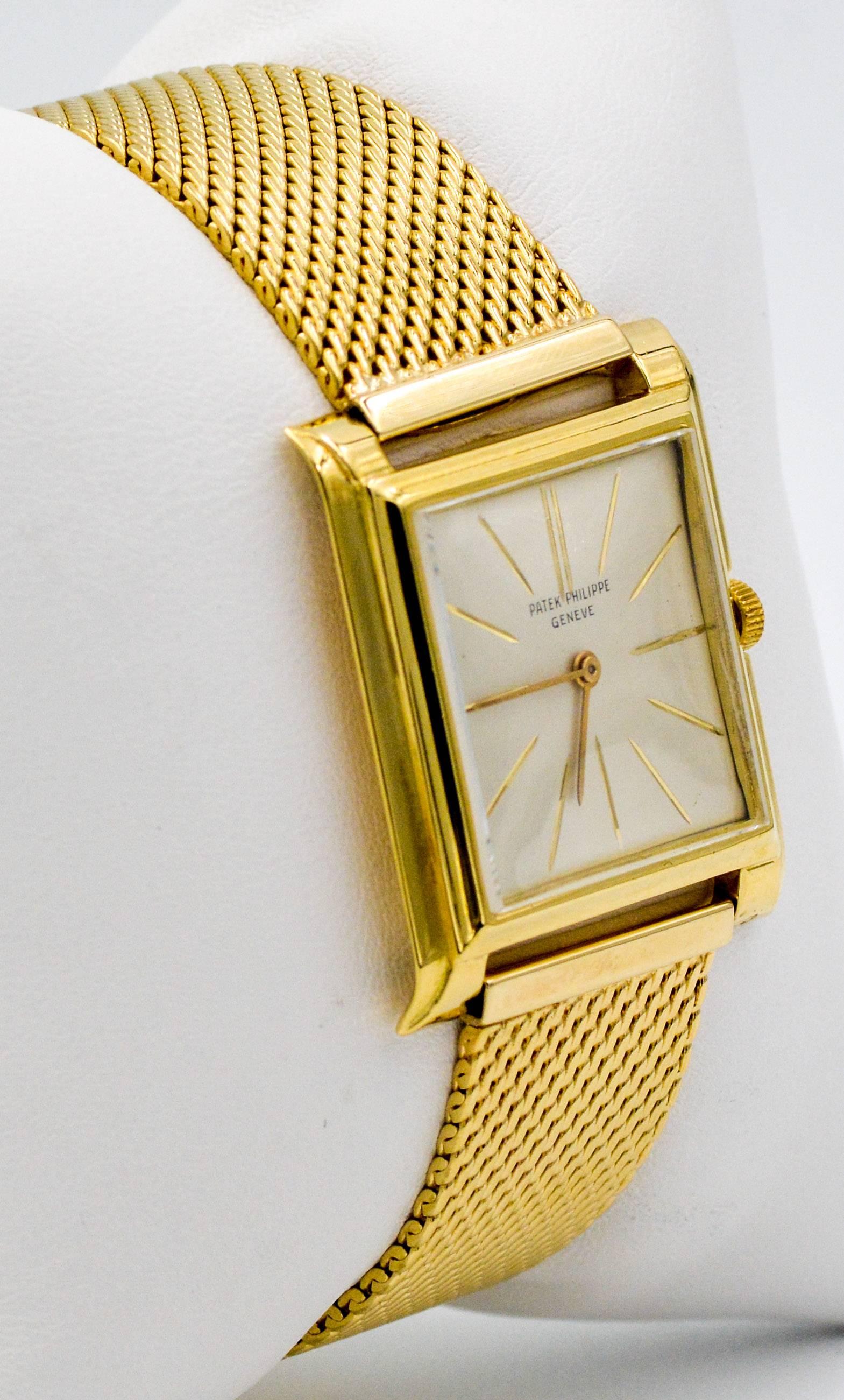 1970s Patek Philippe watch.  This Patek Philippe watch is in amazingly good condition.  It  has a 28 mm case with silvered dial, yellow gold dial indices, sapphire crystal, 18kt yellow gold mesh bracelet, 18kt adjustable fold over clasp, and is a