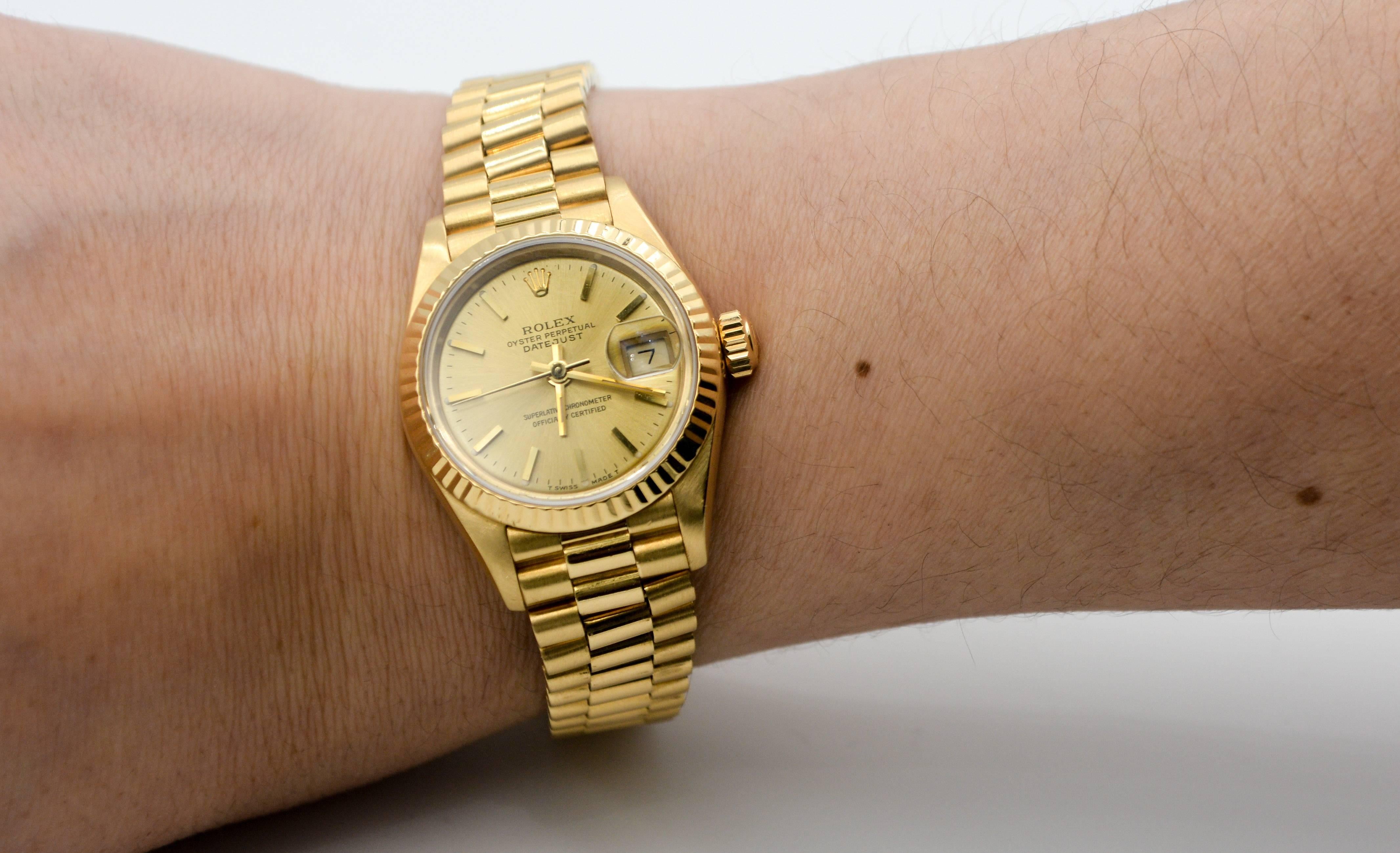 This classic ladies Rolex Datejust President model 69178 is crafted in in 18kt yellow gold. The case is 26 mm and is accented with the classic Rolex Champagne dial and index dial markers.  This Rolex DateJust Presidential was manufatured Circa 1990