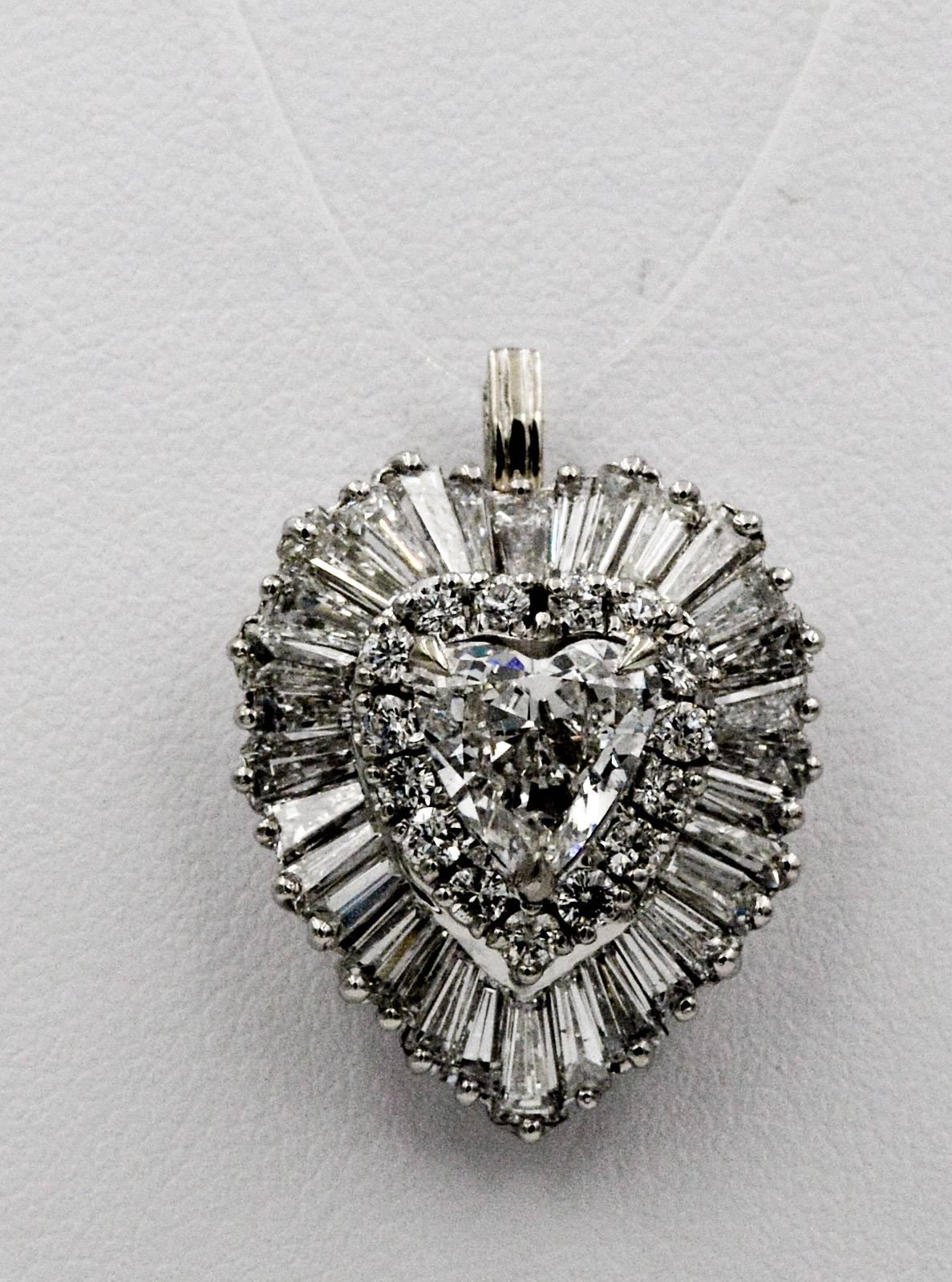 This beuatful ring pendant designed by Ring-Dant is executed in an elegant classic 1970's ballerina style centered with a heart shaped brilliant cut diamond that weighs approximately 1.30 carats with H color and SI1 clarity.  This heart diamond is