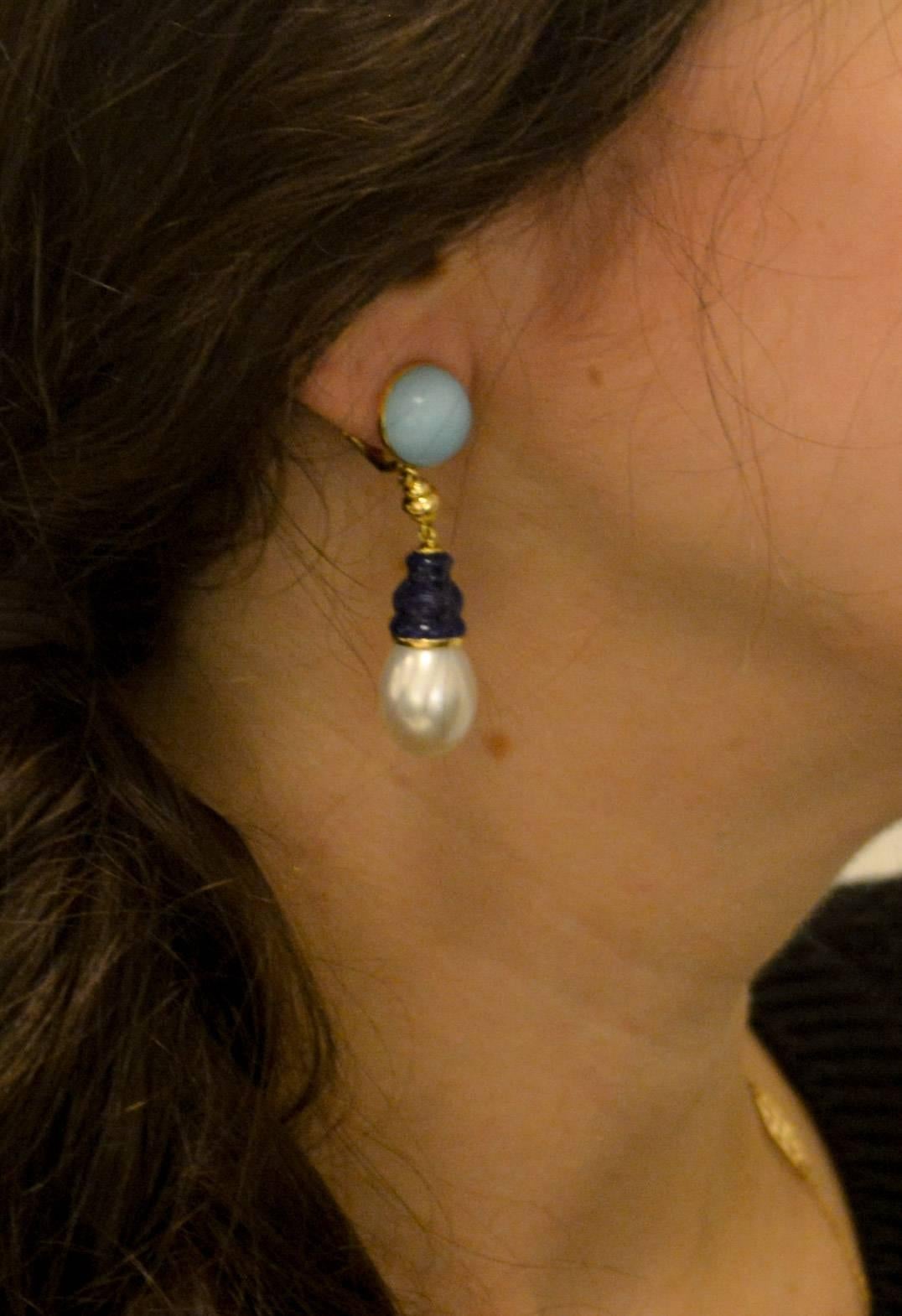 Dazzling pearls complimented by sky blue turquoise and Lapis Lazuli earrings created by Seaman Schepps. Two striking hues of blue in these custom Canton earrings designed with an amazing round cabochon cut bezel set turquoise top. Suspended from the