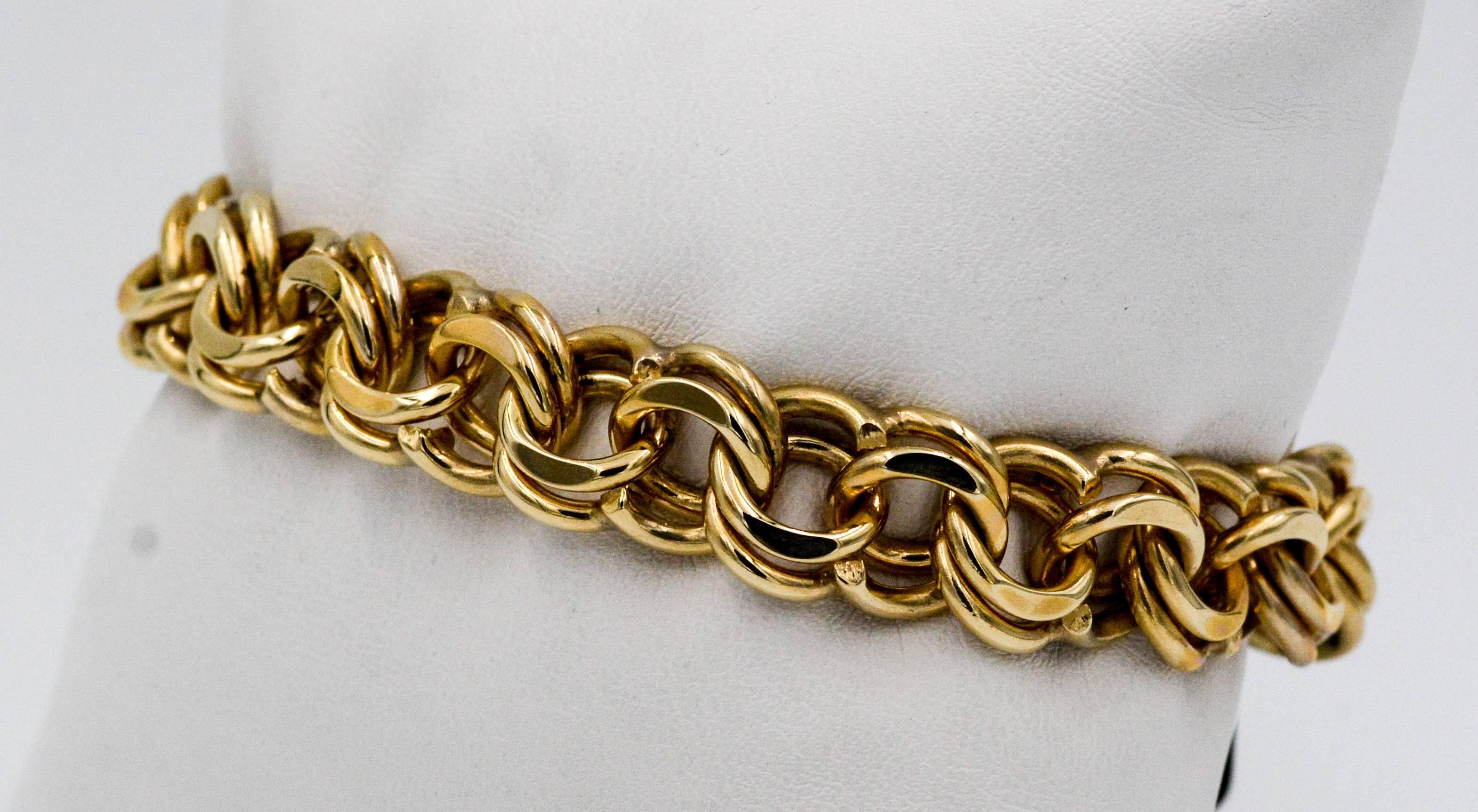This classic 1970s 14kt yellow gold double link charm bracelet chain is 7.5 inches long and measures 11.36 mm wide.  The bracelet is clasped with the traditional tongue and box hidden clasp.  This bracelet is in excellent condition and is ready for