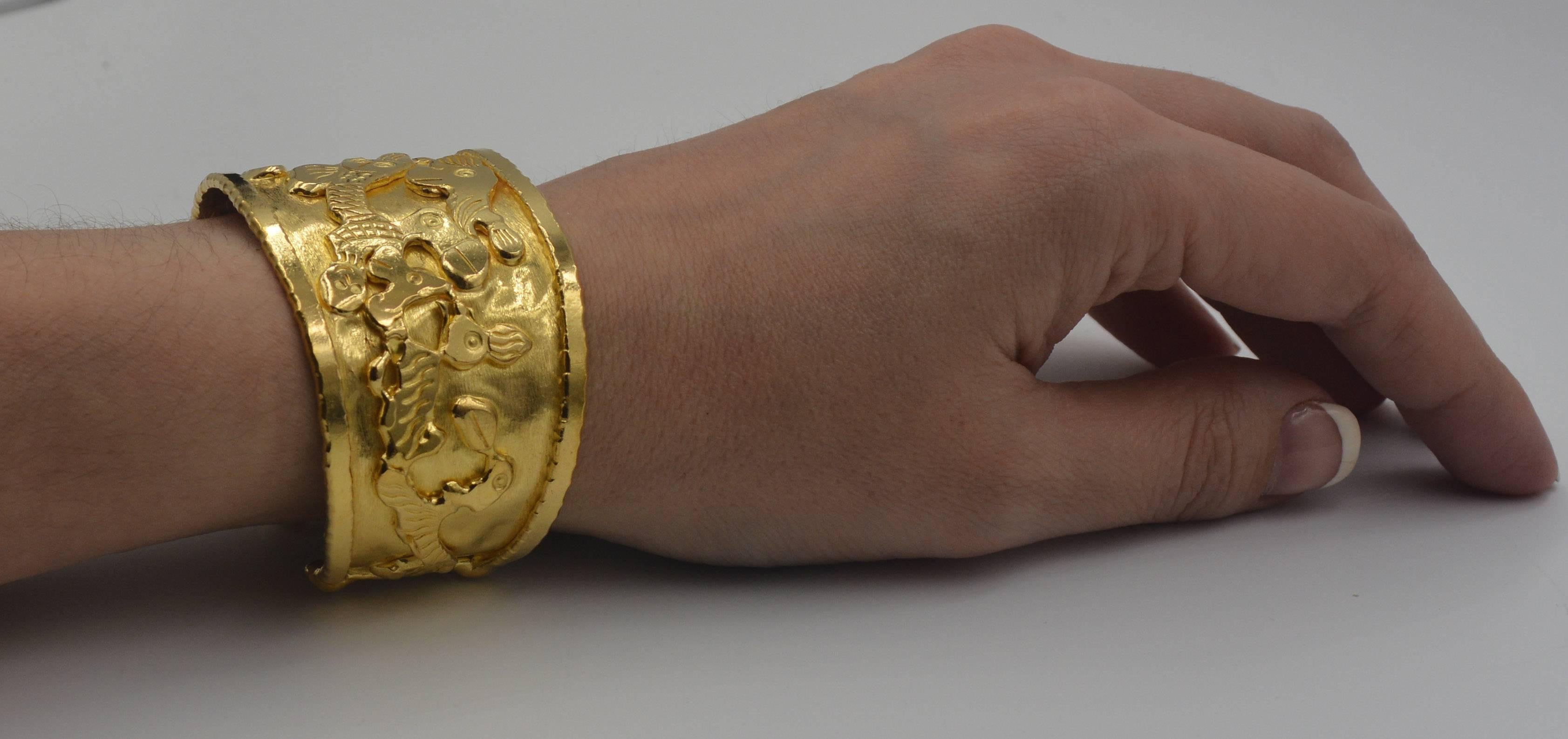 With an eye catching gold bracelet like this gold cuff, people are sure to notice, especially when it's this unique and sought after Jean Mahie 22 karat gold Charming Monsters cuff bracelet. This gold cuff bracelet is an impressive 1 and 7/16th