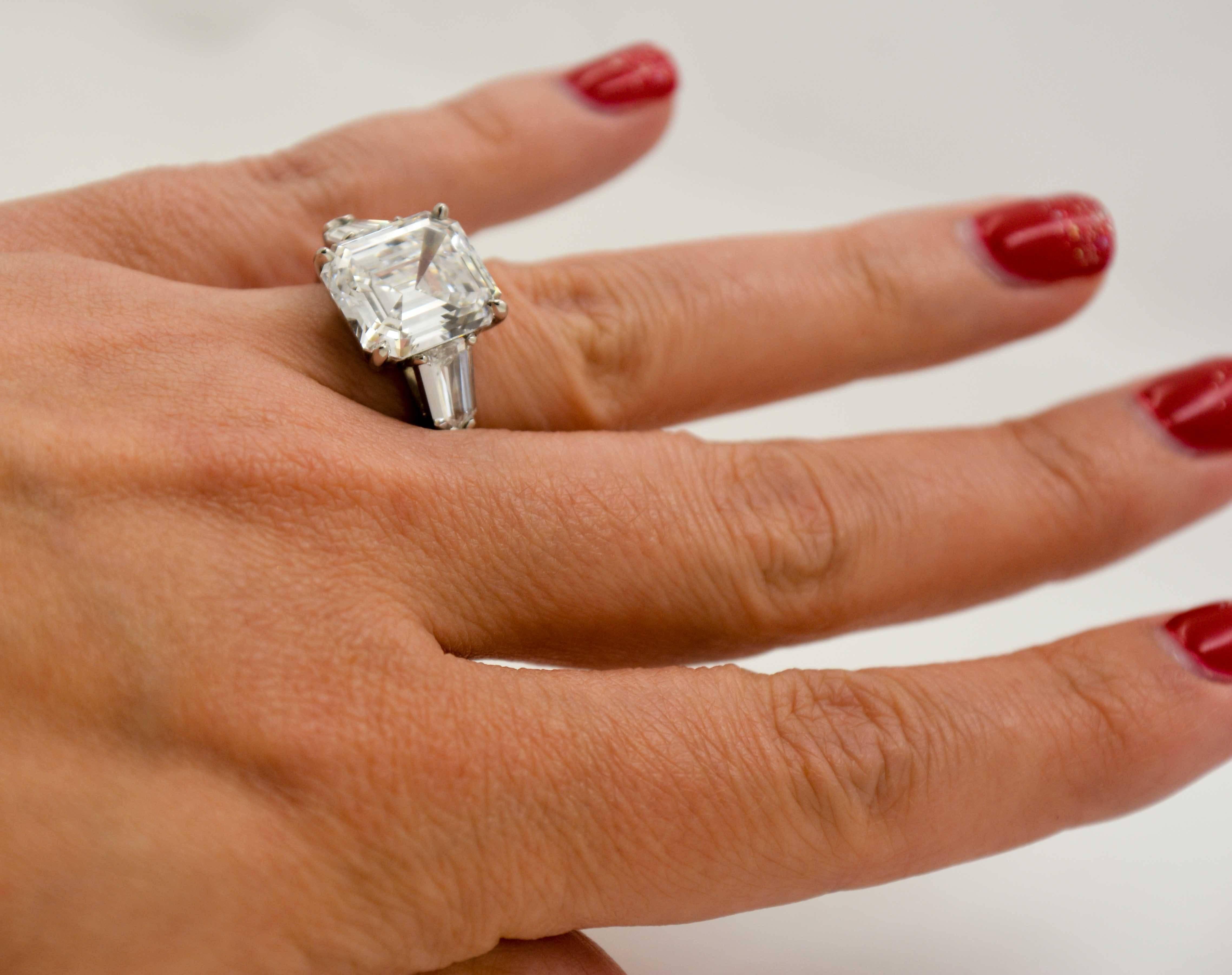 Supremely elegant, this awe-inspiring diamond engagement ring will show off your style. The center stone is an incredible 8.02 carat emerald cut diamond with an unbelievable D color and clarity of VS2 (The diamond comes with a report from the