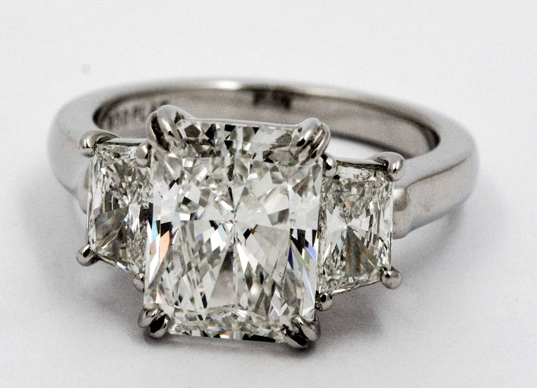 Radiating light by day or night with this glamorous engagement ring, this absolutely stunning radiant cut diamond weighs 4.05 carats with G color and VS2 clarity (ring comes with a diamond report by The Gemological Institute of America).  The