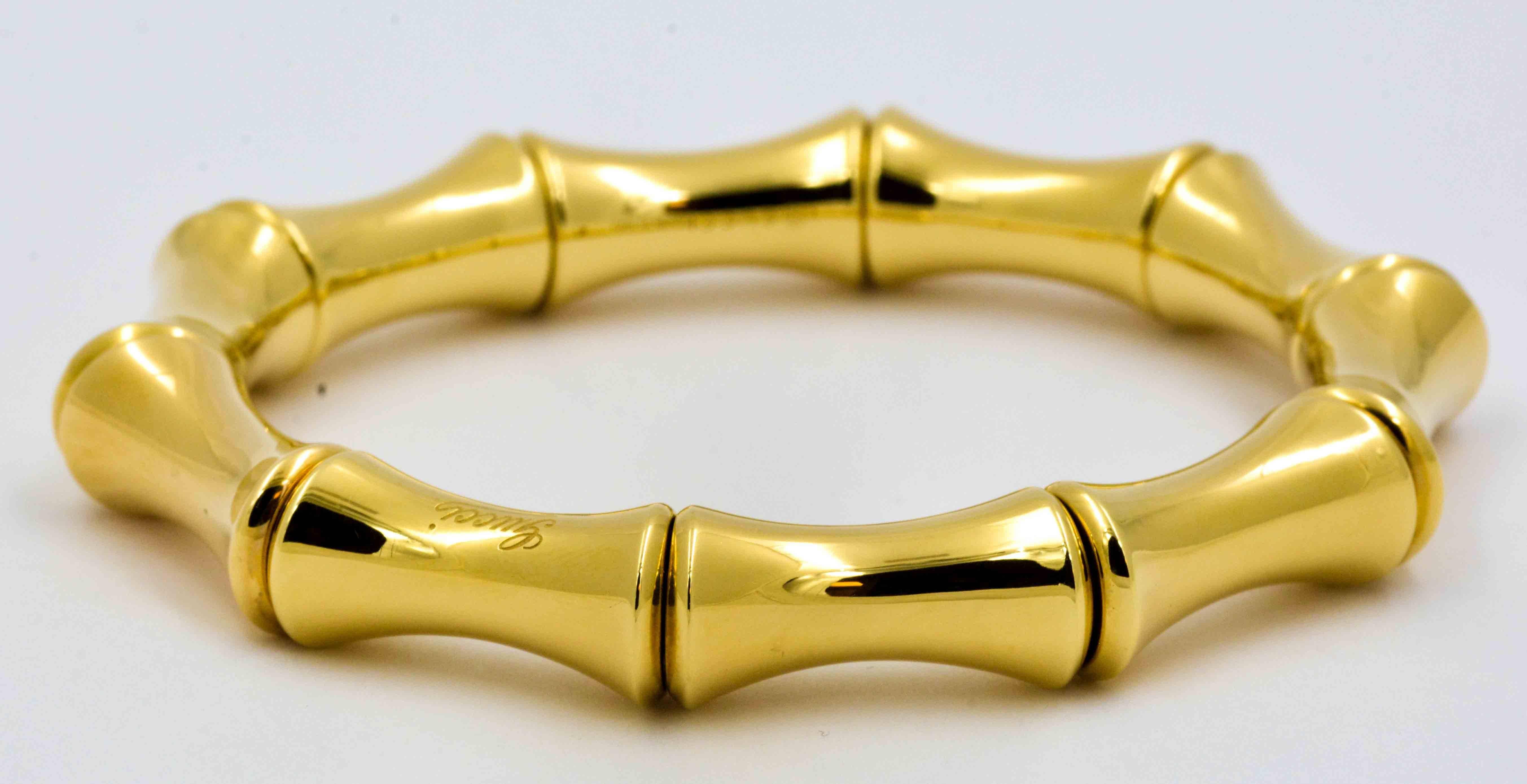 This classic Gucci Bamboo bracelet is crafted in 18kt yellow gold and features the signature Gucci Bamboo motif.  This Gucci bracelet consists of ten bamboo sections that measure 21 mm long and taper from 11.42 mm at the end of each section to 7.65