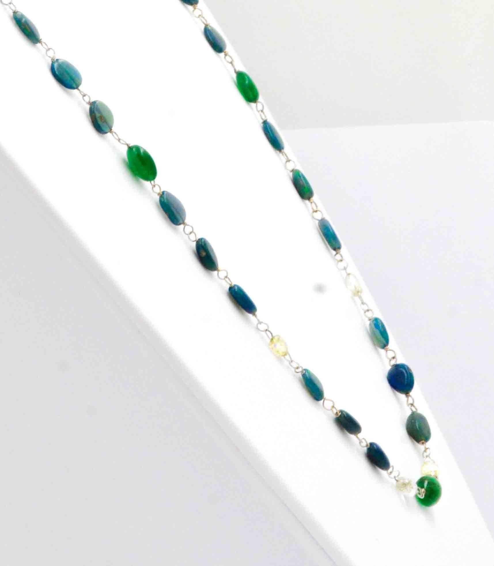 This attractive 18kt yellow gold necklace features beautiful green and blue crystal opal beads with amazing red and orange broad-flash colors.  These amazing crystal opals are contrasted with vivid green emerald beads.  The emerald and opal beads