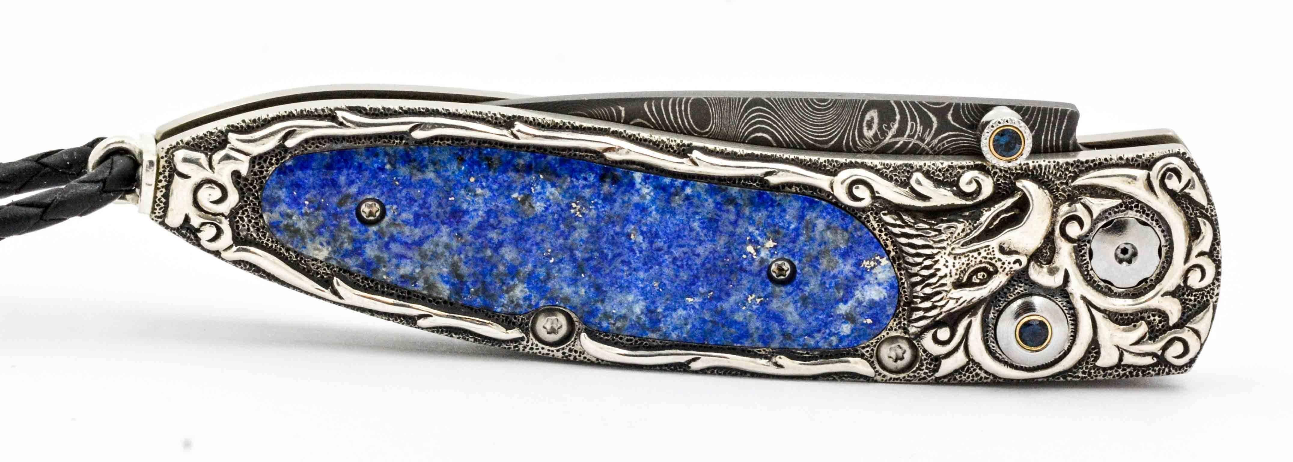 William Henry Designed this amazing Damascus steel knife to feature a leopard skin patterned Monarch shaped blade.  The blade is fixed into an amazing handle that features an artistically carved handle that is embellished with the image of an eagle