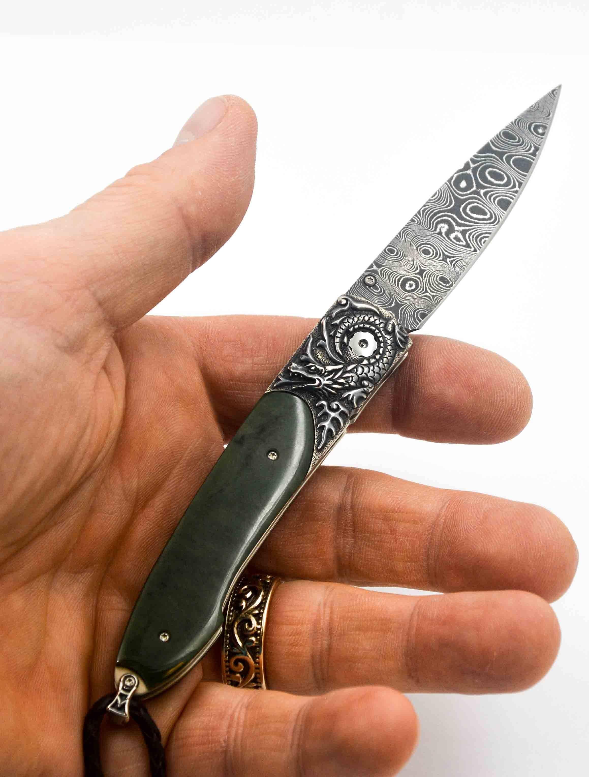 This William Henry Lancet Smaug knife is an excellent example of William Henry quality and William Henry artistry.  The knife features an amazing William Henry Damascus steel blade of leopard skin pattern in the William Henry lance shape.  The