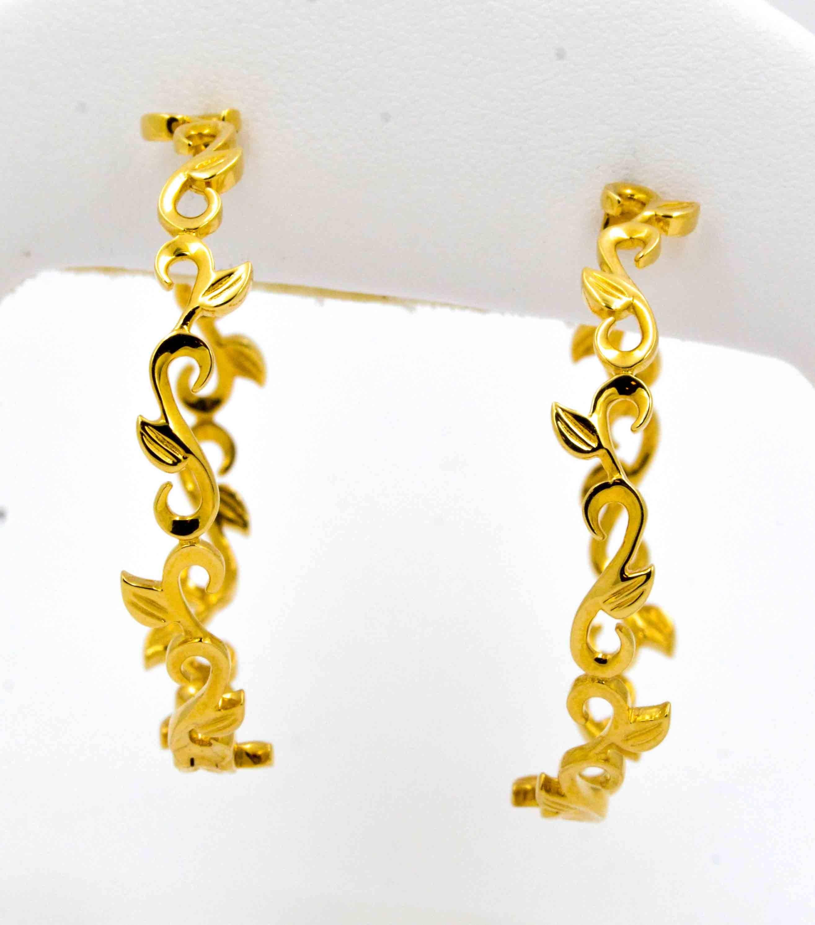 These whimsical Katie Decker gold hoop earrings are crafted in 18kt yellow gold in a flowing ivy style scroll all the way around the earrings.  These gold hoops are 39 mm in diameter which makes these earrings noticeably large, but due to the open