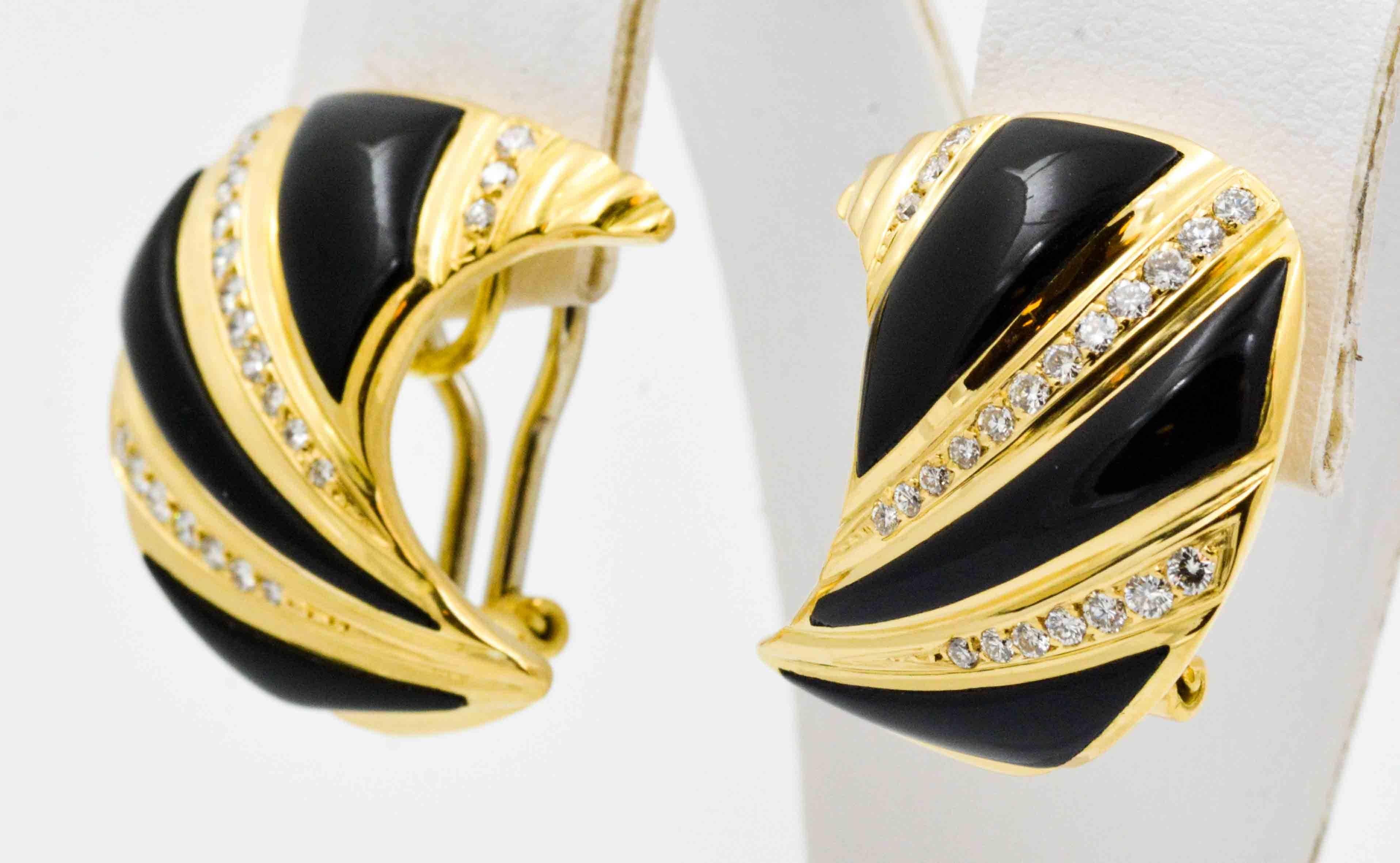 This attractive pair of 18kt yellow gold earrings feature strips of inlay-ed black onyx contrasted with strips of round brilliant cut diamonds.  The pave set round brilliant cut diamonds have an approximate combined weight of 0.75 carats total.  The