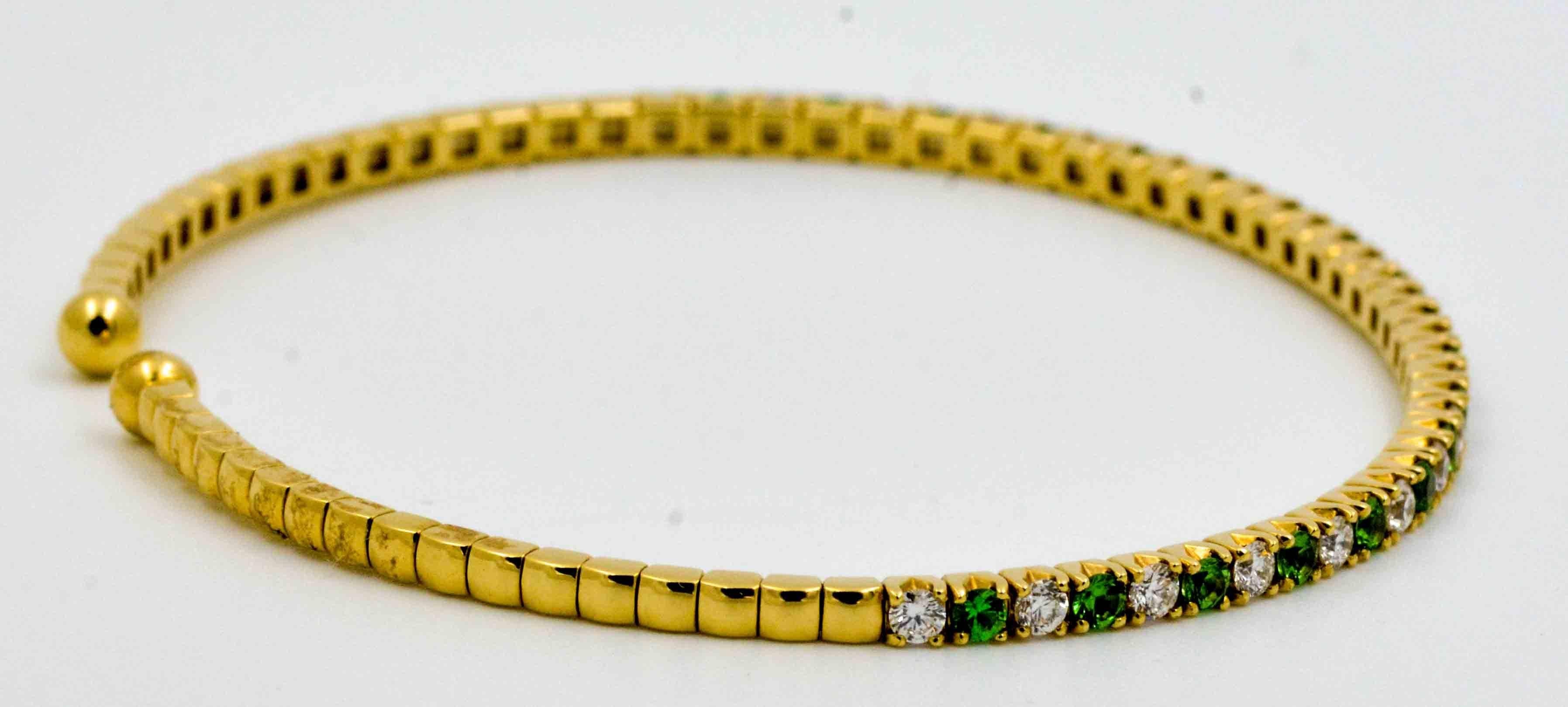 Feminine, functional and fun, this delicate 18kt yellow gold bracelet is set with beautifully contrasting green Tsavorite garnets and graceful white diamonds.  The diamonds have combined weight of 0.60 carats with G-H color and VS clarity.  The