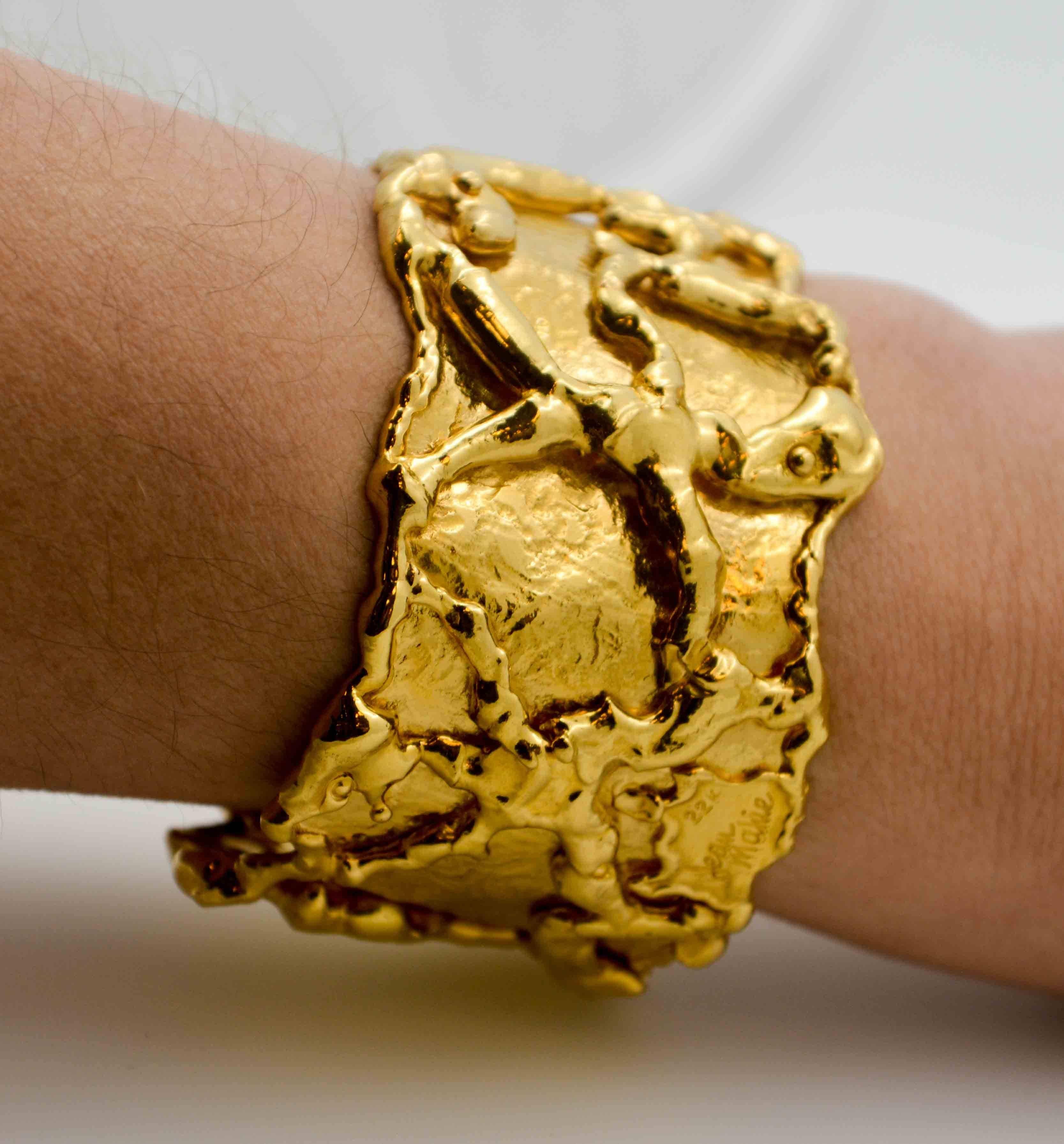 Mad about bold gold? With creative figures carved into this daring bold 22 kt yellow gold cuff bracelet, you'll dazzle with every move of your wrist. Jean Mahie created this dramatic 22 kt gold cuff bracelet to be worn with a flamboyant air. Go