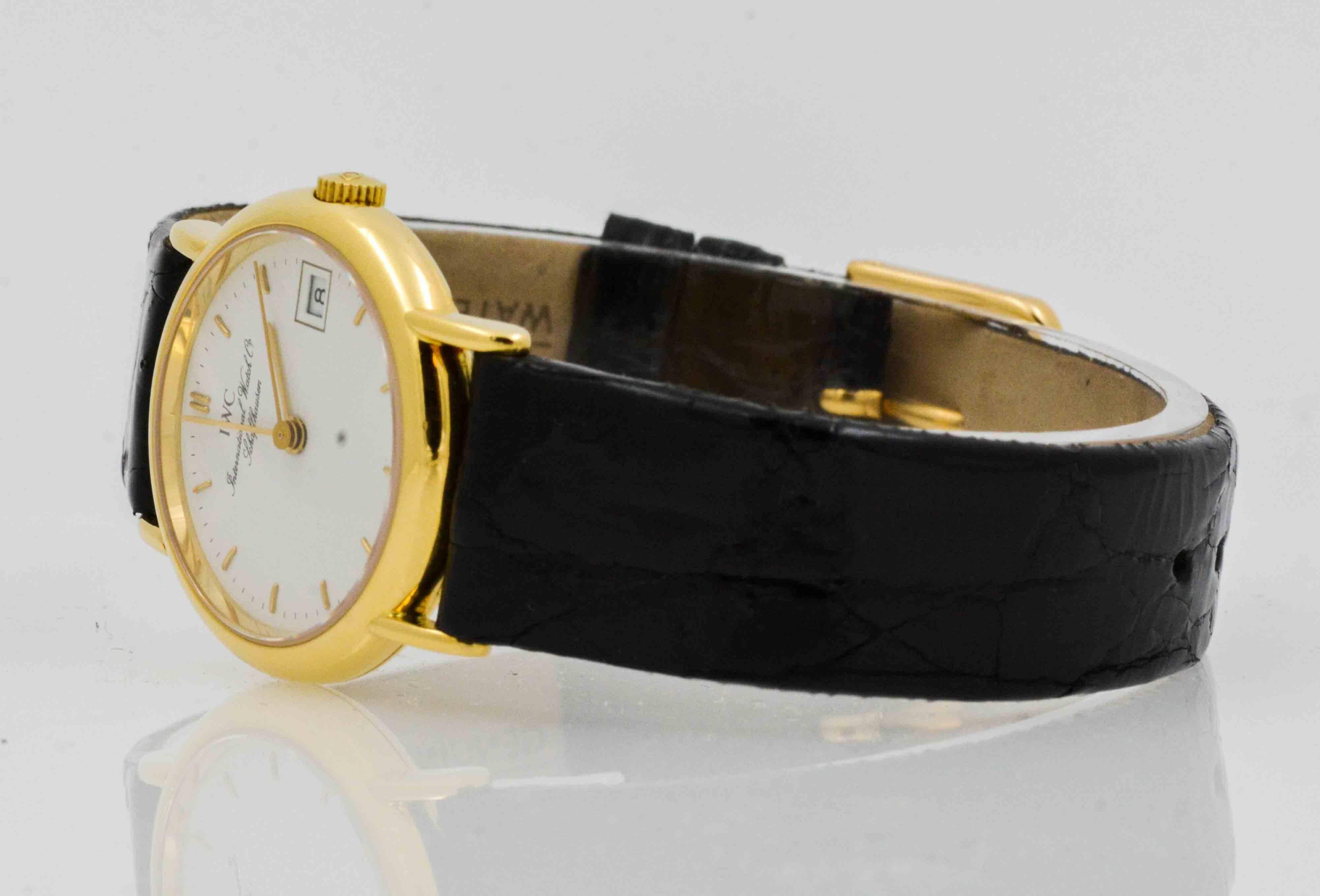 International Watch Company (IWC) 26 mm ladies watch in 18 Karat yellow gold with white index dial. Date, second hand, quartz movement. Black crocodile strap with Ardillion buckle. Certified pre-owned and recently serviced.