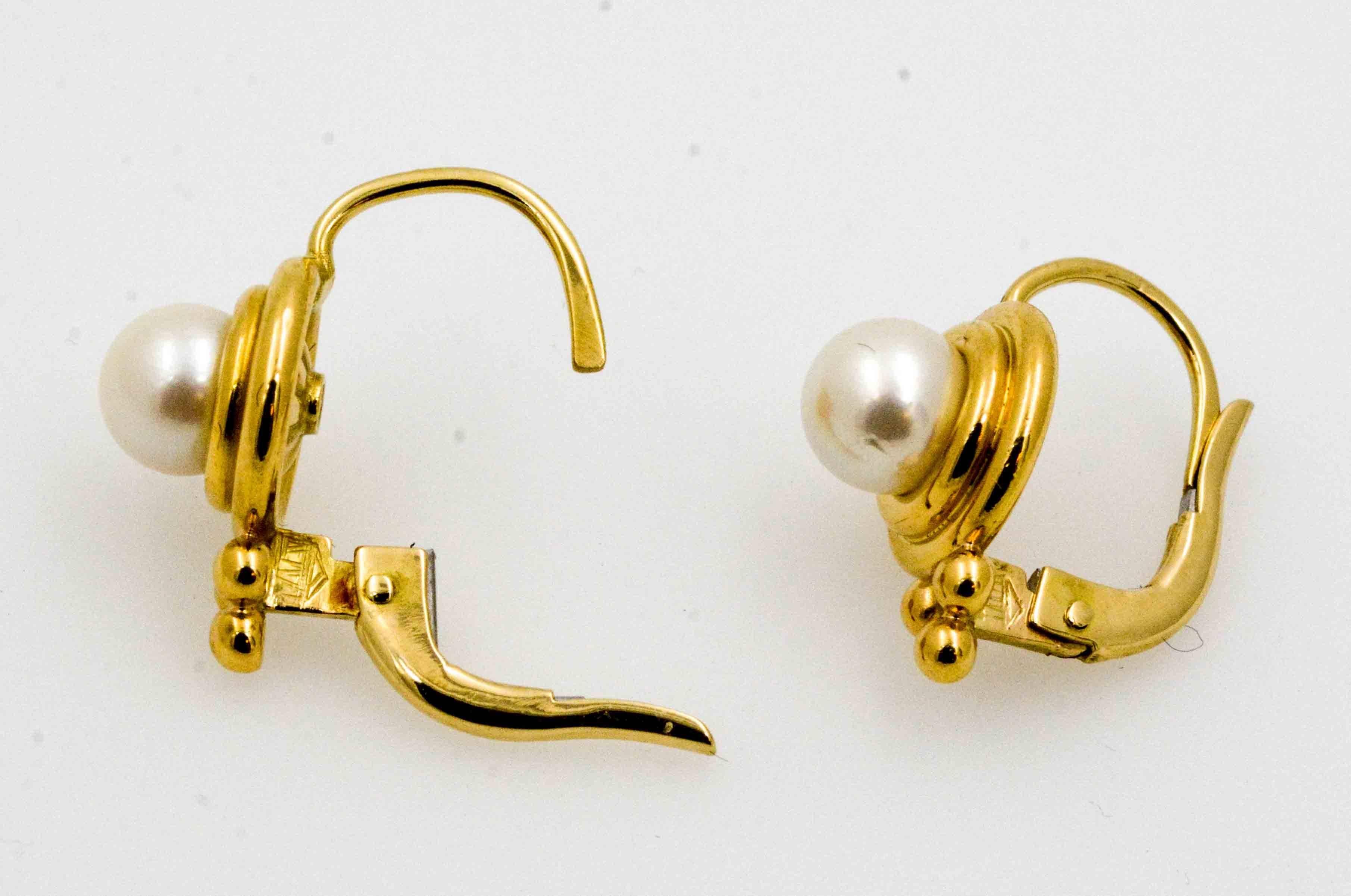 18 karat gold surrounds white cultured pearls in these classy Temple St. Clair lever back earrings. Crafted in Italy in 18 karat yellow gold, and set with beautiful white cultured pearls. These elegant earrings are ready for daytime or evening