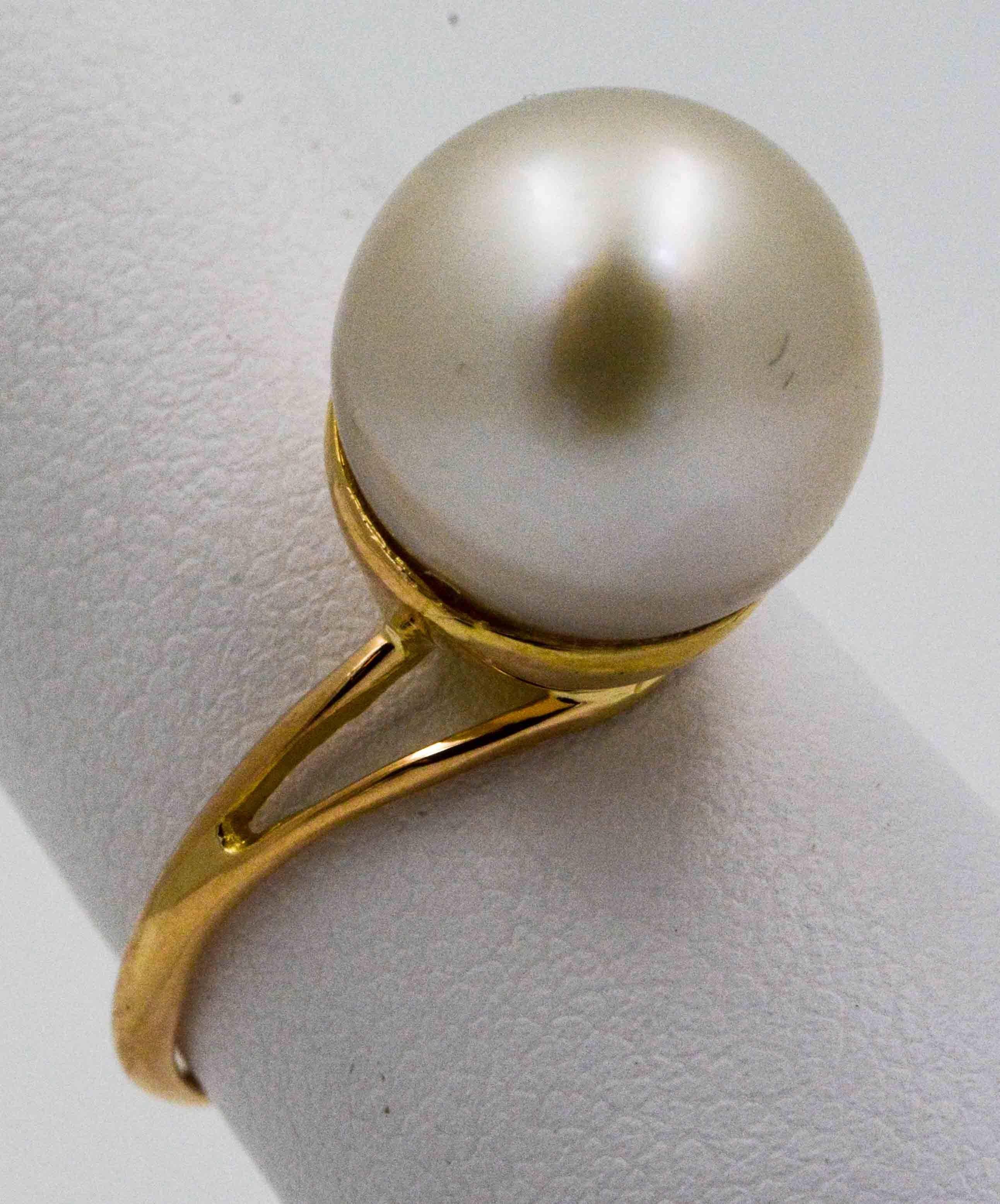 A classic white South Sea 12 mm cultured pearl is the centerpiece of this simply elegant ring. This commanding South Sea pearl is set on a thin 18 karat yellow gold ring, and is perfect for any occasion. 