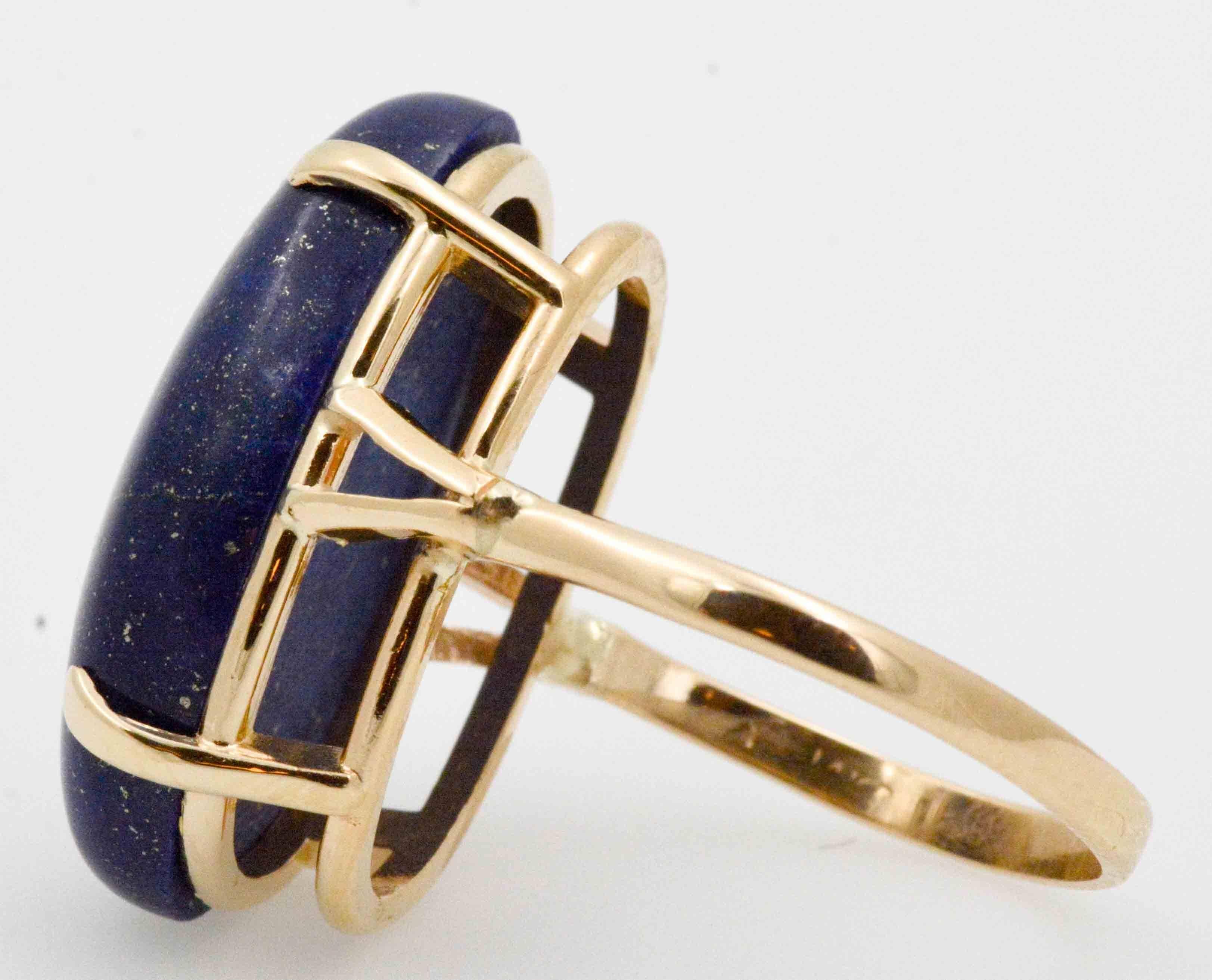 Like a starry evening sky, perfect little speckles dot this deep blue oval Lapis Lazuli. The 14 karat yellow gold ring complements the golden spangled 15.75 carat Lapis Lazuli. Currently a finger size 8, this ring may be sized as necessary, and has