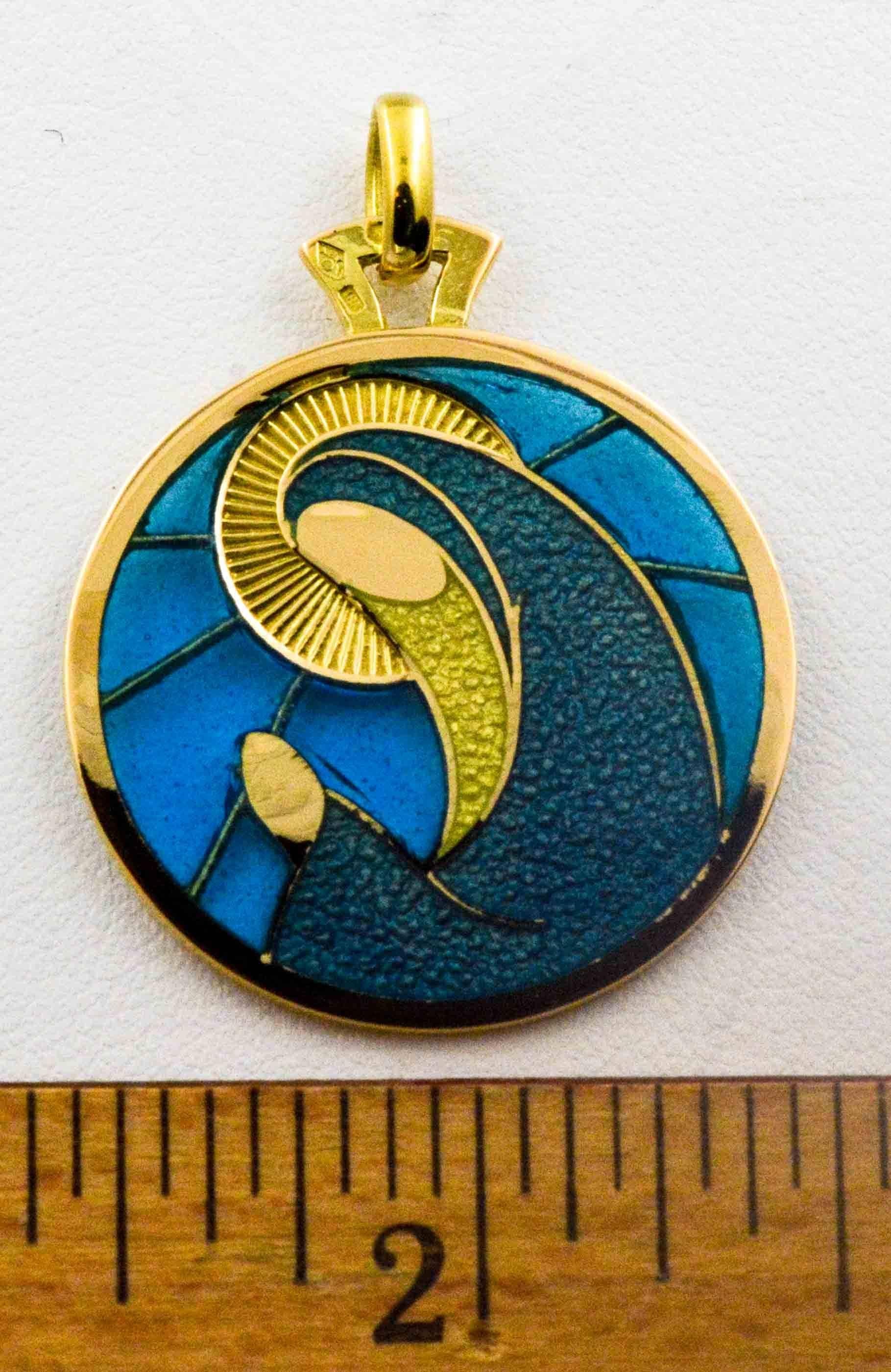 In calming blues, this hand enameled Plique a Jour Virgo pendant is light and delicate and crafted with intricate details in 18 karat yellow gold.  This pendant will delight the Virgo in your life.