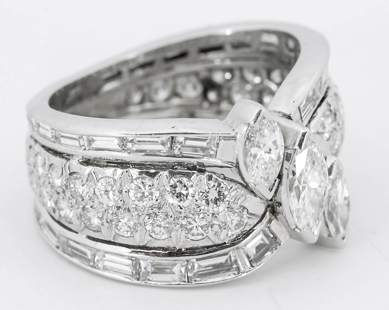 This striking and beautiful piece of jewelry is fashioned from platinum, three marquise cut diamonds, 38 round brilliant cut diamonds, and 38 baguette cut diamonds. The approximate weight of the diamonds is 4.00 carats, G-H color and SI clarity. The