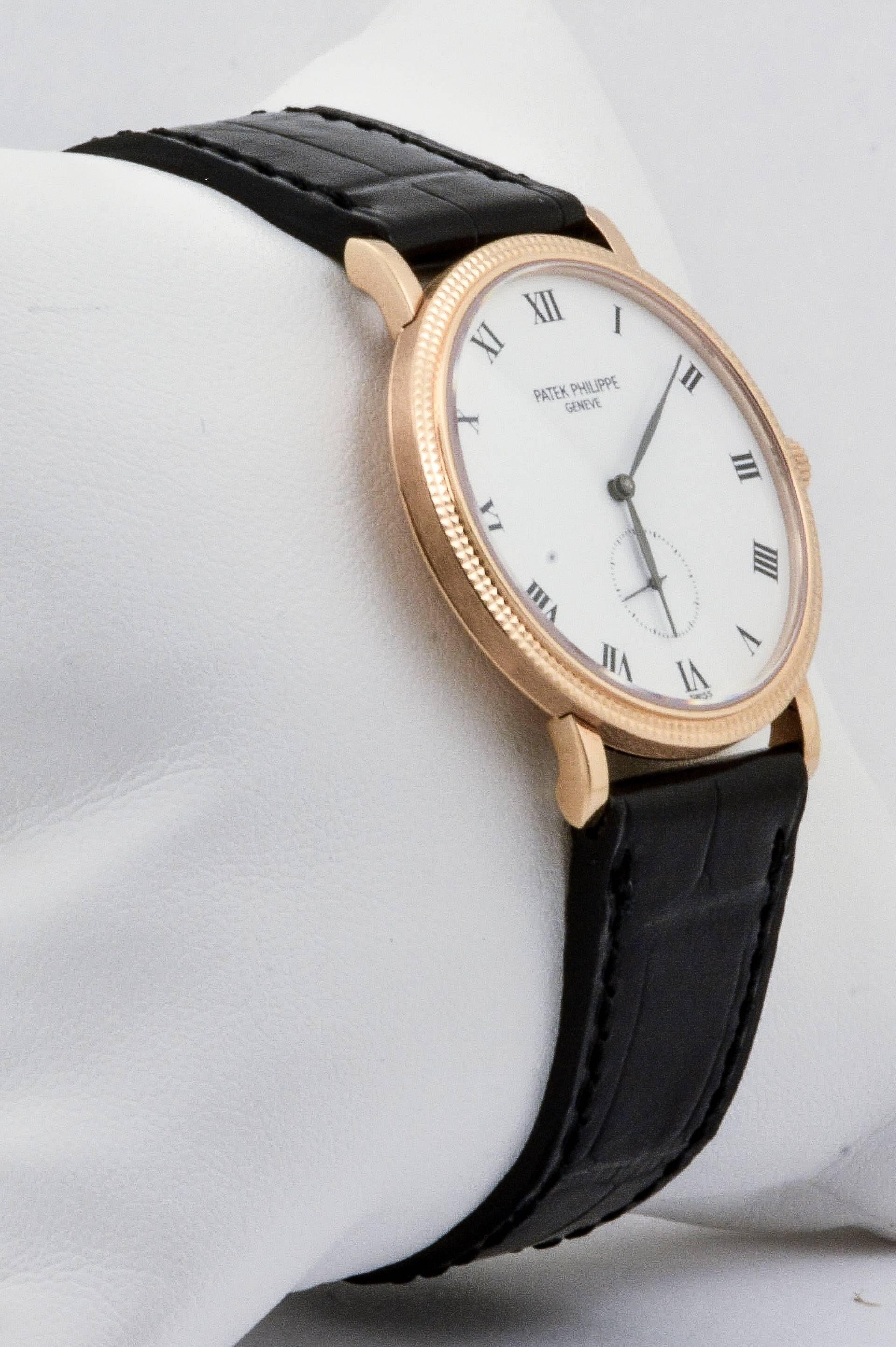 This certified pre-owned Patek Philippe Calatrava 33mm watch is artfully designed to accentuate its 18kt rose gold with a shimmering white dial face. This watch features Roman numeral dial markers, a hobnail bezel, a sapphire crystal, and a sleek