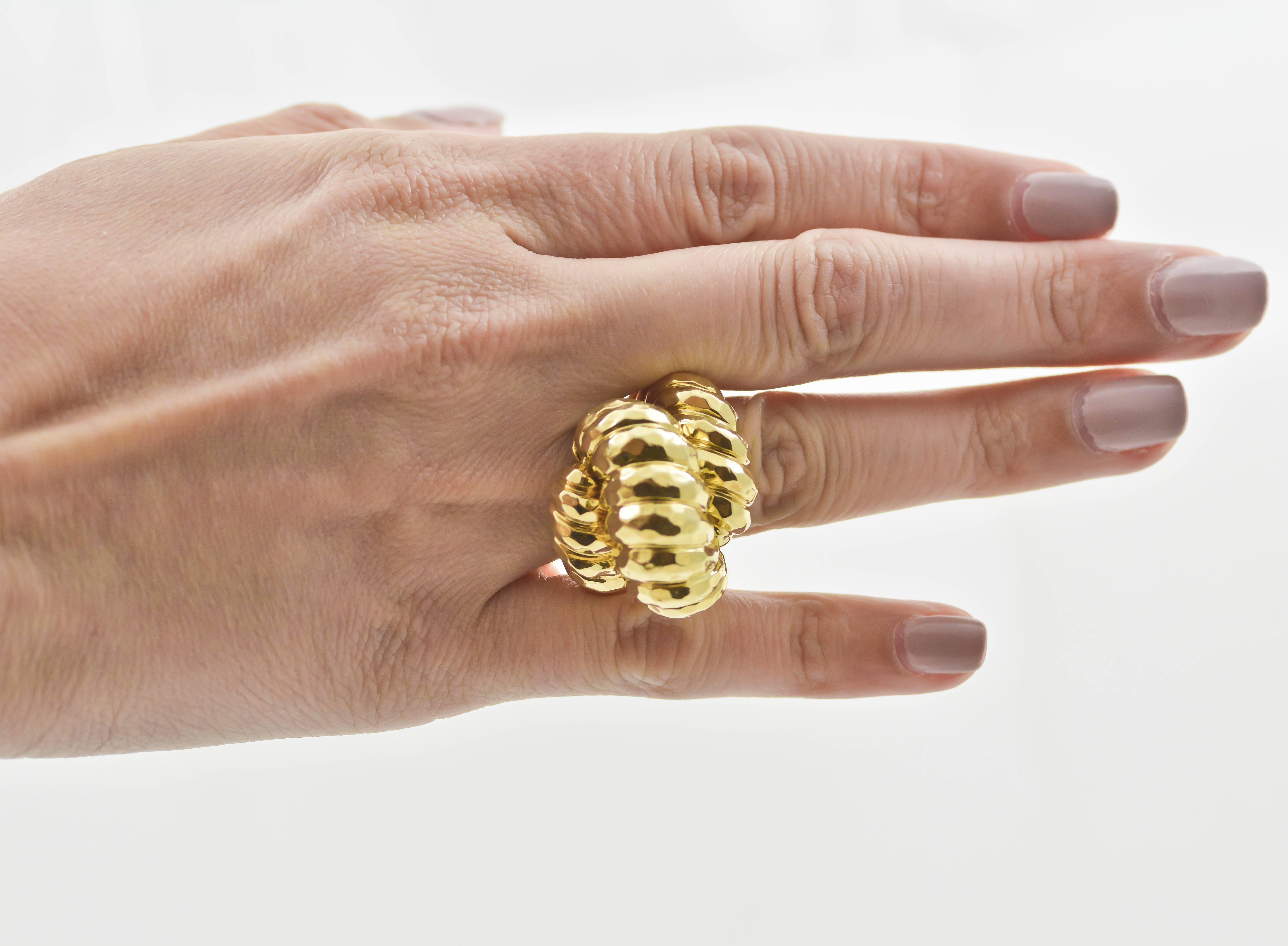 This ring, designed by Henry Dunay, is a vintage 18kt yellow gold piece made to draw the eye with its quintessential Henry Dunay style finish that reflects light with a multi-faceted surface. The gold sweeps flawlessly around the wearer’s finger,