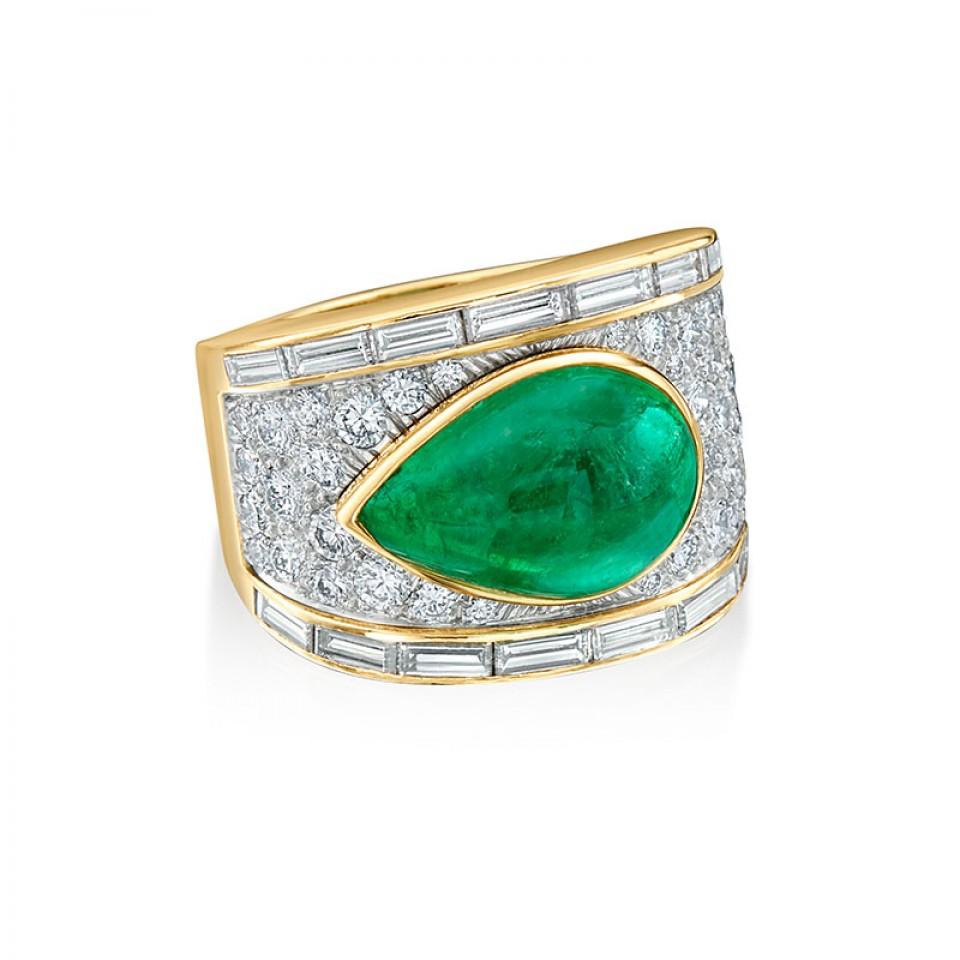 Driven by art, design, and bold pieces this emerald ring embodies David Webb’s geometric and brightly colored stone statements. The ring is set with an approximate 10.46 carat pear cabochon emerald in 18 karat yellow gold with platinum; surrounded