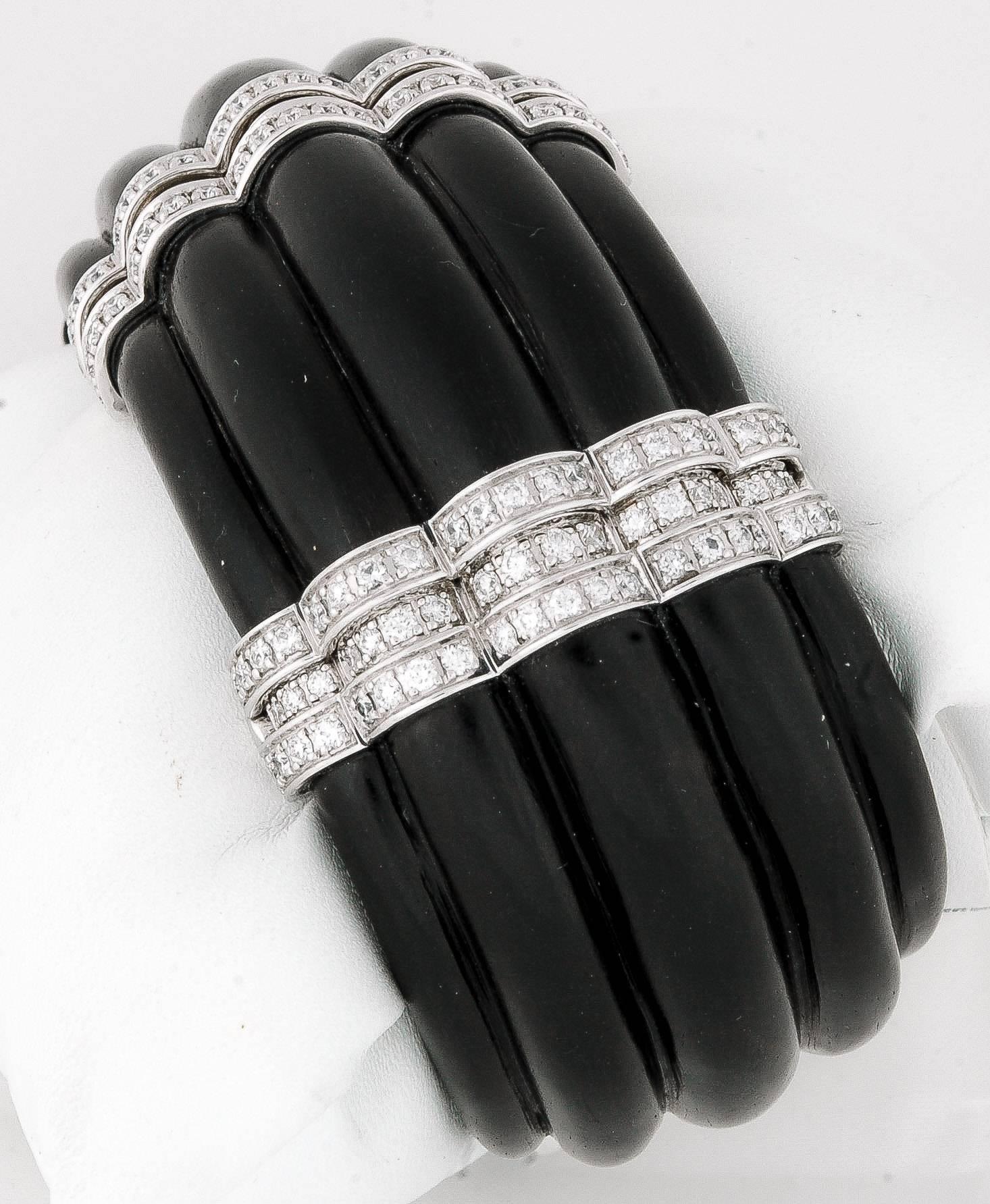 18kt white gold and stunning carved ebony are embellished with 165 round brilliant cut diamonds weighing a total of 4.02 carats, giving this cuff bracelet a hint of elegance and style.