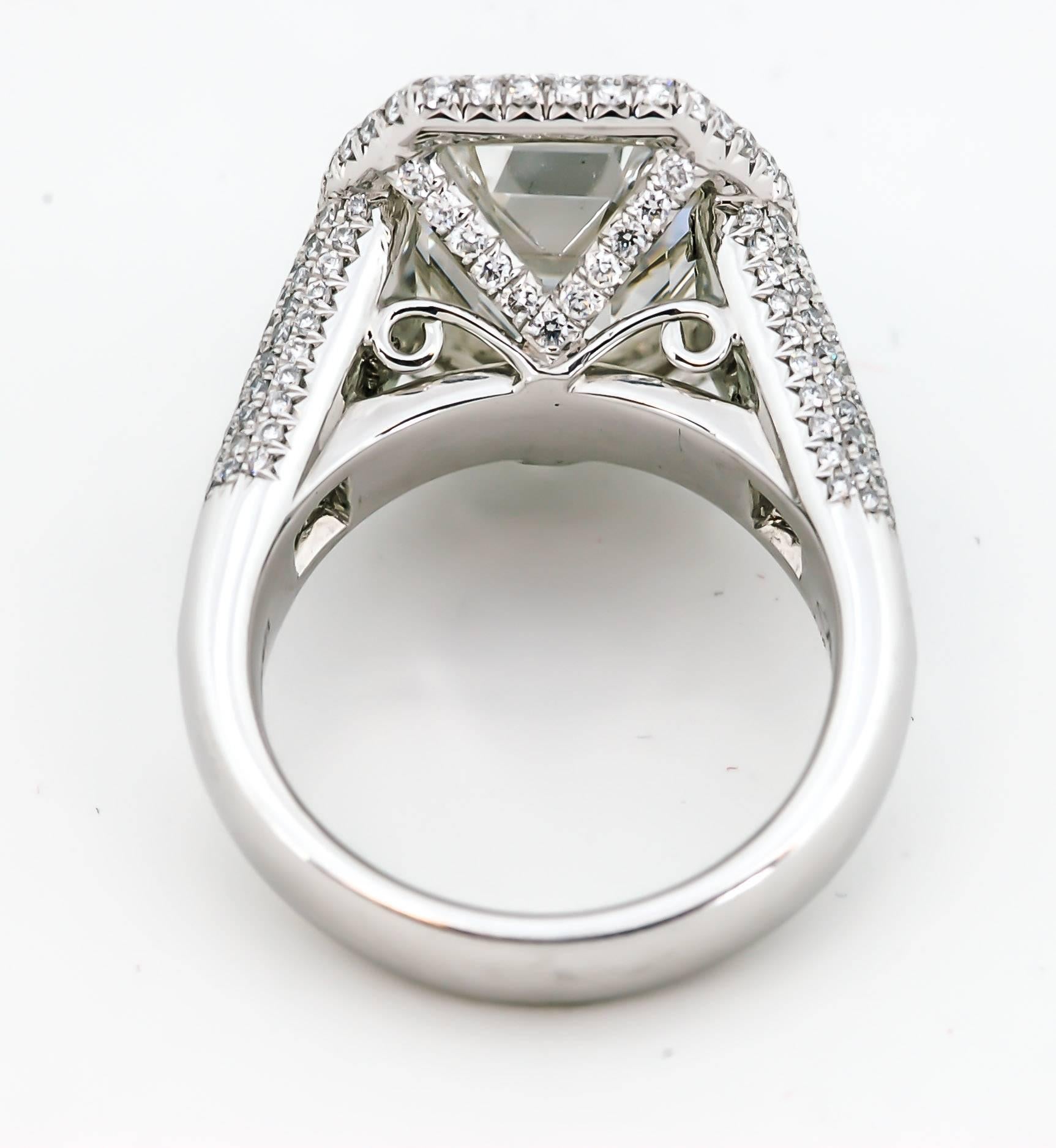 This ring is expertly crafted to sparkle and stun with its 7.25 carat octagonal emerald cut diamond (clarity VS1 color H; GIA report 11317831). Eight trapezoid cut diamonds weighing 1.65 carats (clarity VS color G) shine from their place in the
