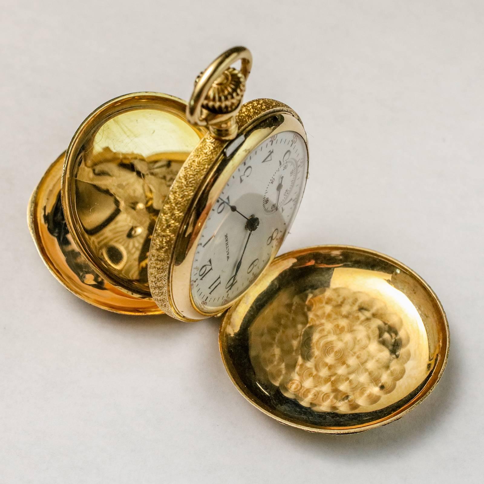 Small 14k gold multi-colored pocket watch by WALTHAM. Case heavily detailed with multi-colored gold overlay, including an intricately executed basket of flowers on the back side and an engraved medallion on the front.  Watch features clean numerals
