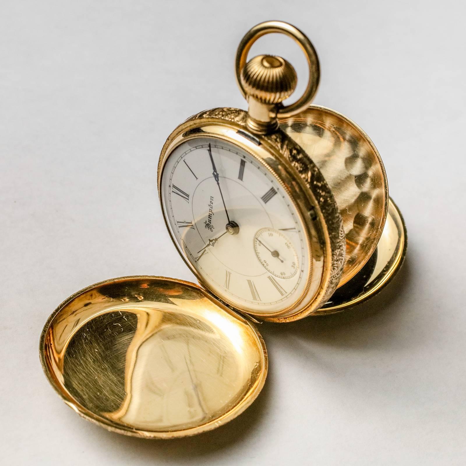 Large gold filled antique pocket watch by HAMPDEN Watch Co.  Case features multi-colored gold overlay with beautifully detailed flowers on both sides.  Large medallion on front can be engraved.  Unusual lever pulls out for setting time (vs. stem