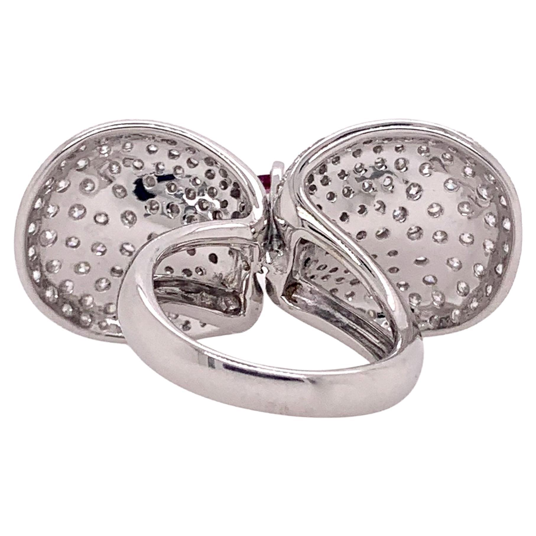 Stunning 18k white gold GIA certified sapphire in a flower motif diamond setting.  The 1.57 ct. heated sapphire is a GIA certified with a vibrant pinkish - purple hue.   The round brilliant diamonds equate to 4.23 cts and is masterfully set in the