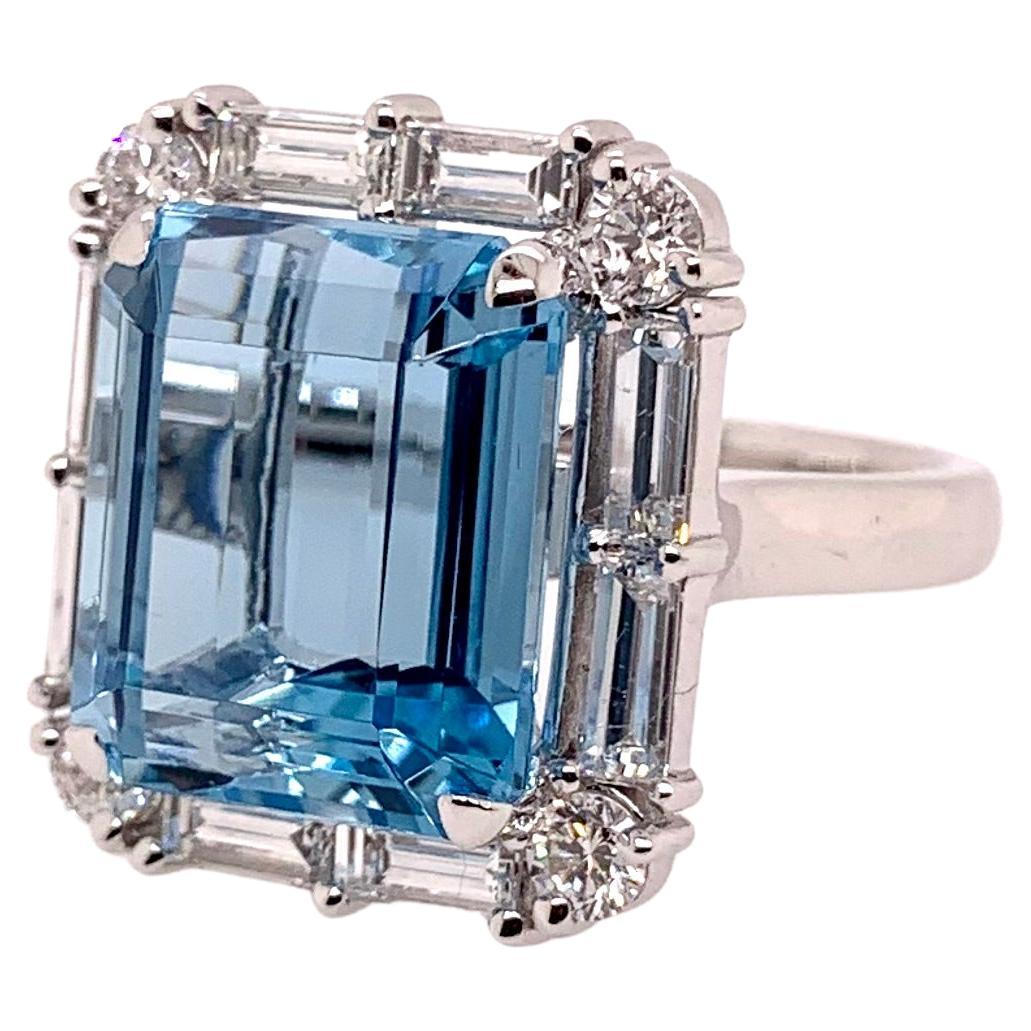 This stunning, ocean blue aquamarine has amazing blue hues and is cut exceptionally well to radiate in any environment.   The setting is handmade in platinum and is precisely surrounded by handpicked diamond baguettes and round diamonds that