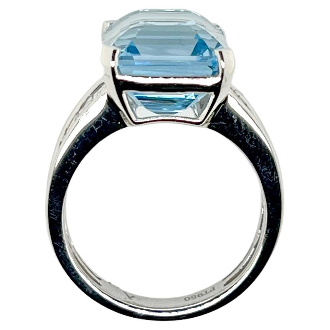 A stunning ocean blue aquamarine ring set in an iconic baguette diamond setting that is slightly tapered in a platinum handmade mounting.  The crisp, blue hue aquamarine weights a generous 9.55 carats while the specially selected baguettes come in