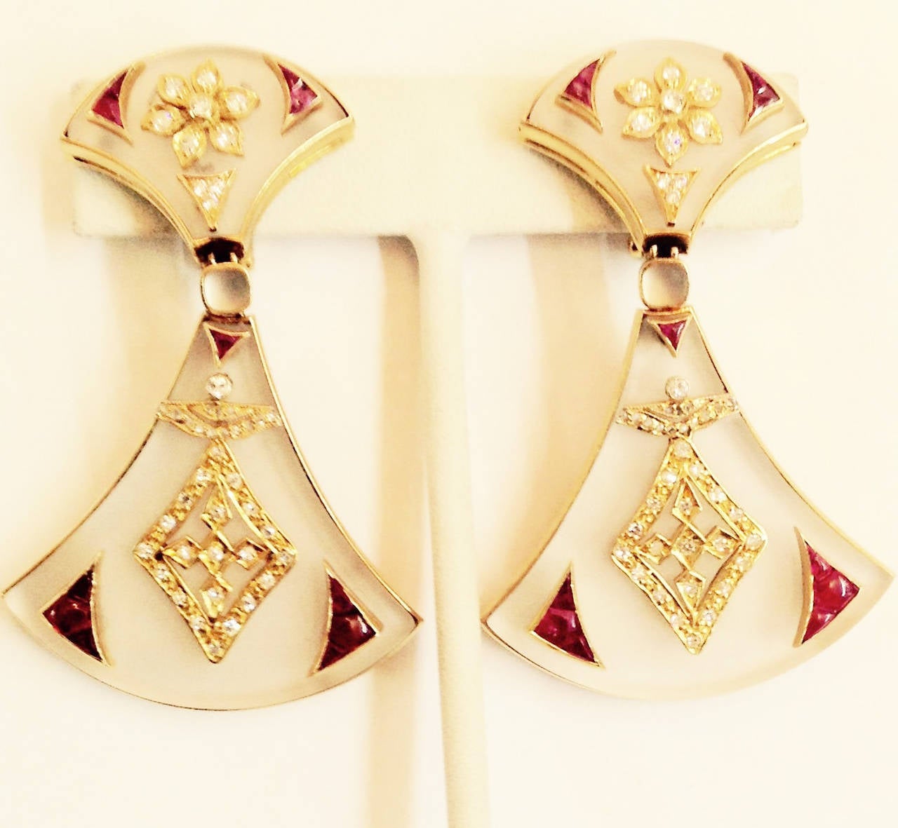 18kt yellow gold unusual Asian influenced design Frosted Rock Crystal Earrings Embellished with numerous Full cut diamonds in shape of a floral design further encrusted with custom cut buff cut Burmese High quality Rubies with beautiful color and