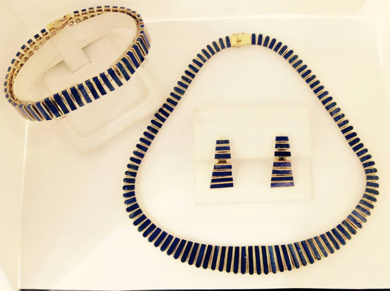 18kt yellow gold and high quality lapis lazuli suite may be worn on gold side this suite is reversible, consisting of one highly flexible necklace 16 inches in length and width is 3/4 of an inch wide bracelet in suite measuring 7 inches in length