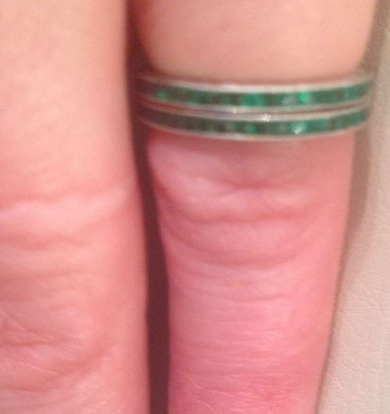 Pair Of Platinum And French Cut Emeralds, Hand Engraved Eternity Bands.
Ring Size 5.