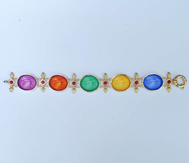 18 Kt. Yellow Gold Etched Intaglio Bracelet, Embellished With 6 Cabochon Rubies and 5 Engraved, Colored Glass Panels With Large Spring Ring Closure.