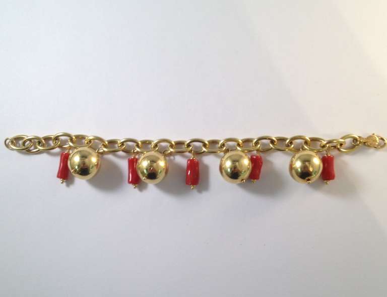 18 Kt, Yellow Gold Barrel Cut Oxblood Coral And Gold Ball, Flexible Link Bracelet, Designed By Primavera, Made In Italy. Circa 1980's.