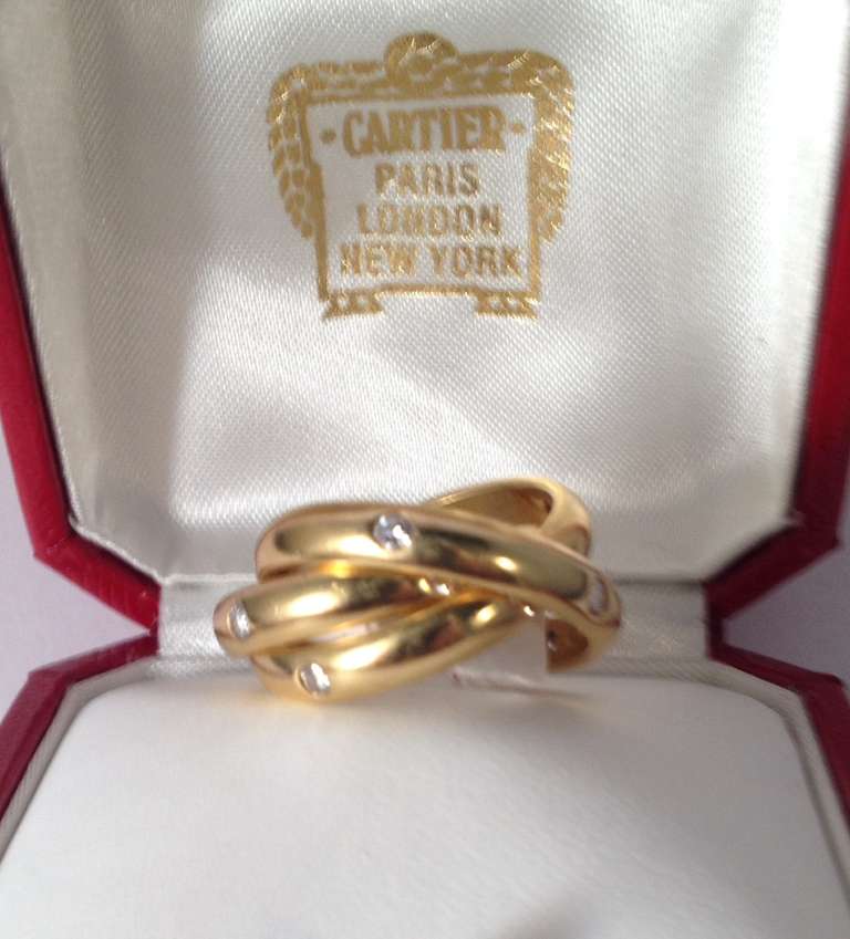 18 Kt. Yellow Gold Triple Intertwined, Rolling Rings With Invisible Set, High Quality, Full Cut Diamonds, Signed Cartier, Made In France. Ring Size 7. 15 Diamonds, With A Total Weight Of Approximately 1 Ct.