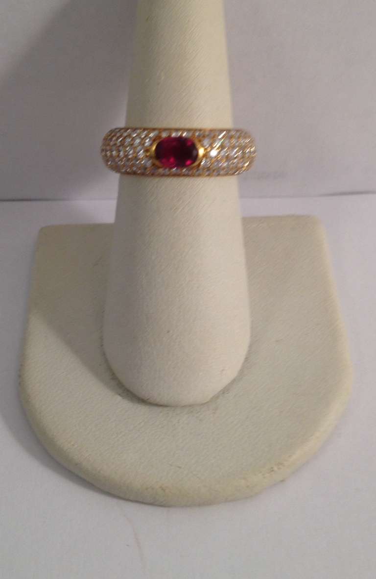 18 Kt. Yellow Gold, Rounded Effect Band Designed With Numerous, High Quality, Full Cut Diamonds, Weighing Approximately 1.50 Cts, Centering .50 Ct.Faceted, Oval Ruby, Signed With Hallmark For H. Stern. Ring Size 6, May Be Sized To Any Ring Size