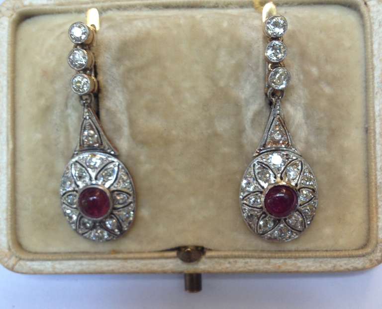 1920's Art Deco Platinum And 18kt gold Backs Cabochon Ruby And Diamond Drop Pendant Earrings For Pierced Ears. Diamond Weight Approximately !.50 cts And Rubies Weighing Approximately 50 ct each Total Weight of Rubies 1 carat with exempflying