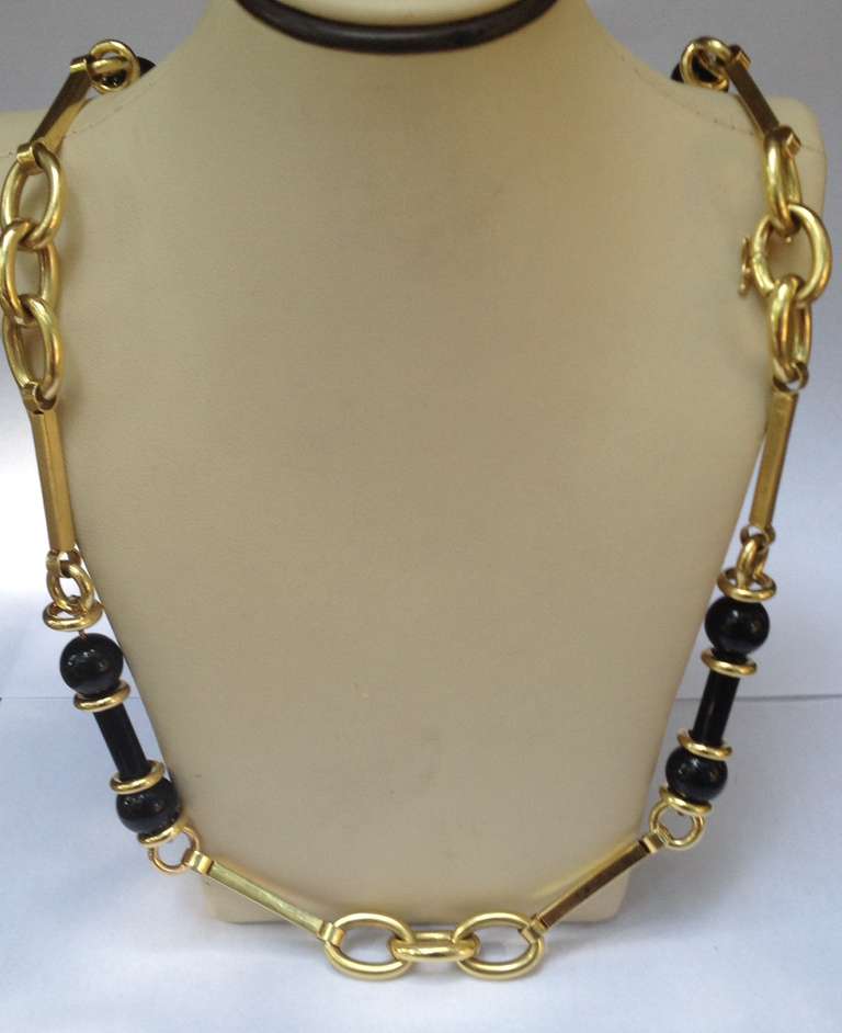 18kt yellow gold adjustable length chain necklace consisting of round cut and barrel cut onyxes and open link and rectangular alternating link design pieces may be worn at 33 inches and 27and 1/2 inches and 23 inches it separates in three pieces 