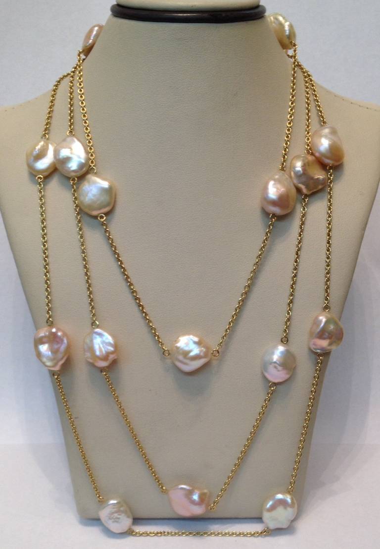 18kt kt yellow gold chain necklace embellished with {20] Pink high quality lustre baroque pearls entertwined by a handmade rope design 18kt yellow gold rope chain may be worn doubled