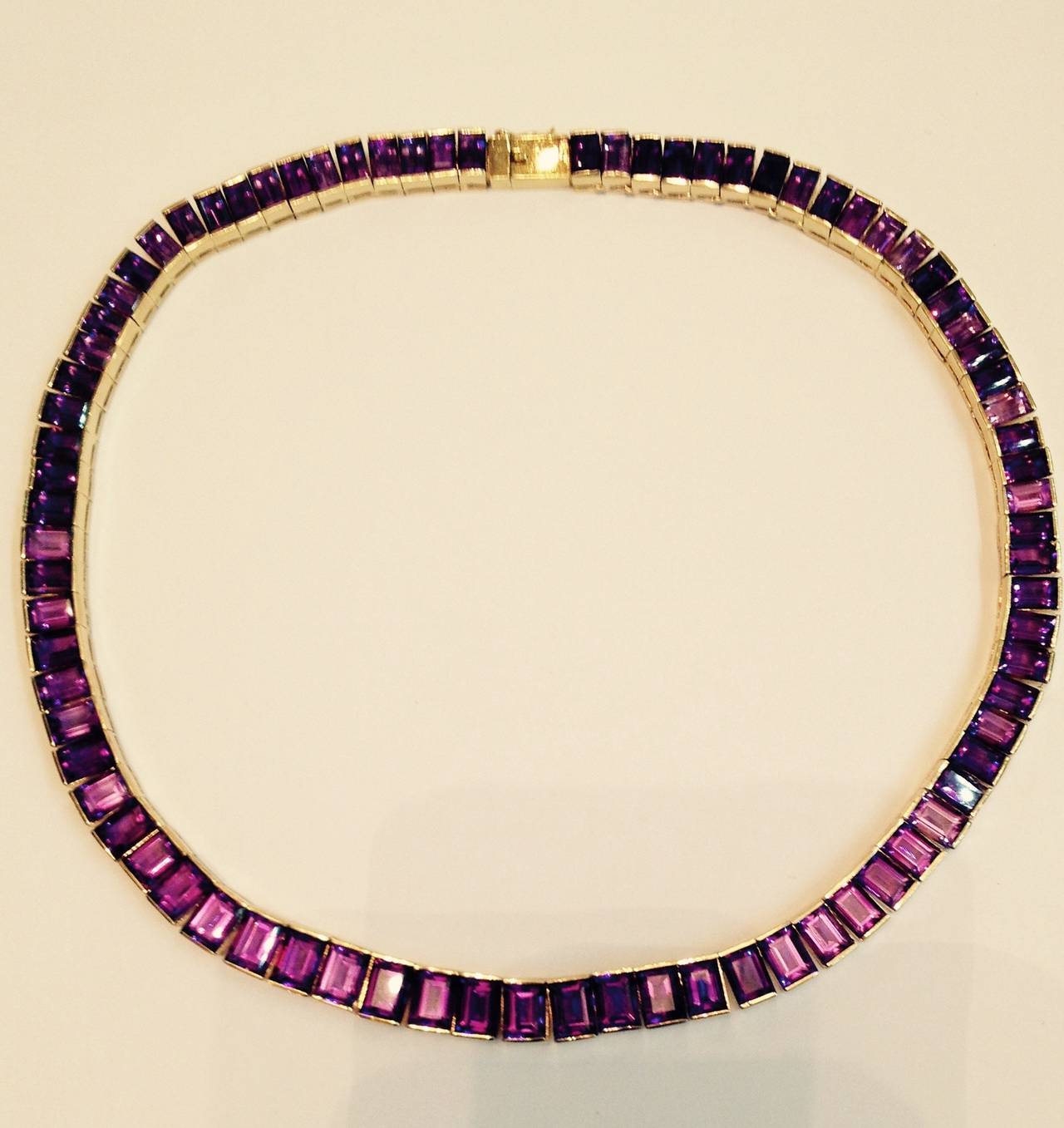 14kt yellow gold intense and beautiful color amethyst straightline necklace consisting of {90} Baguette cut high quality amethysts very flexible and beautifully made 15 and 1/2  inches wearable glissteneing irridescent stones circa 1960's european