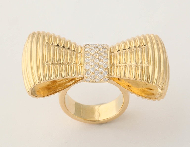 18kt yellow gold Fanciful Jumbo Figural Gold & Diamond Bow Tie Ring centering approximately 1 .25 cts of high quality full cut diamonds and exhibiting very well made ridged gold workmanship to resemble a crinkled bow tie knot. Excellent Craftmanship